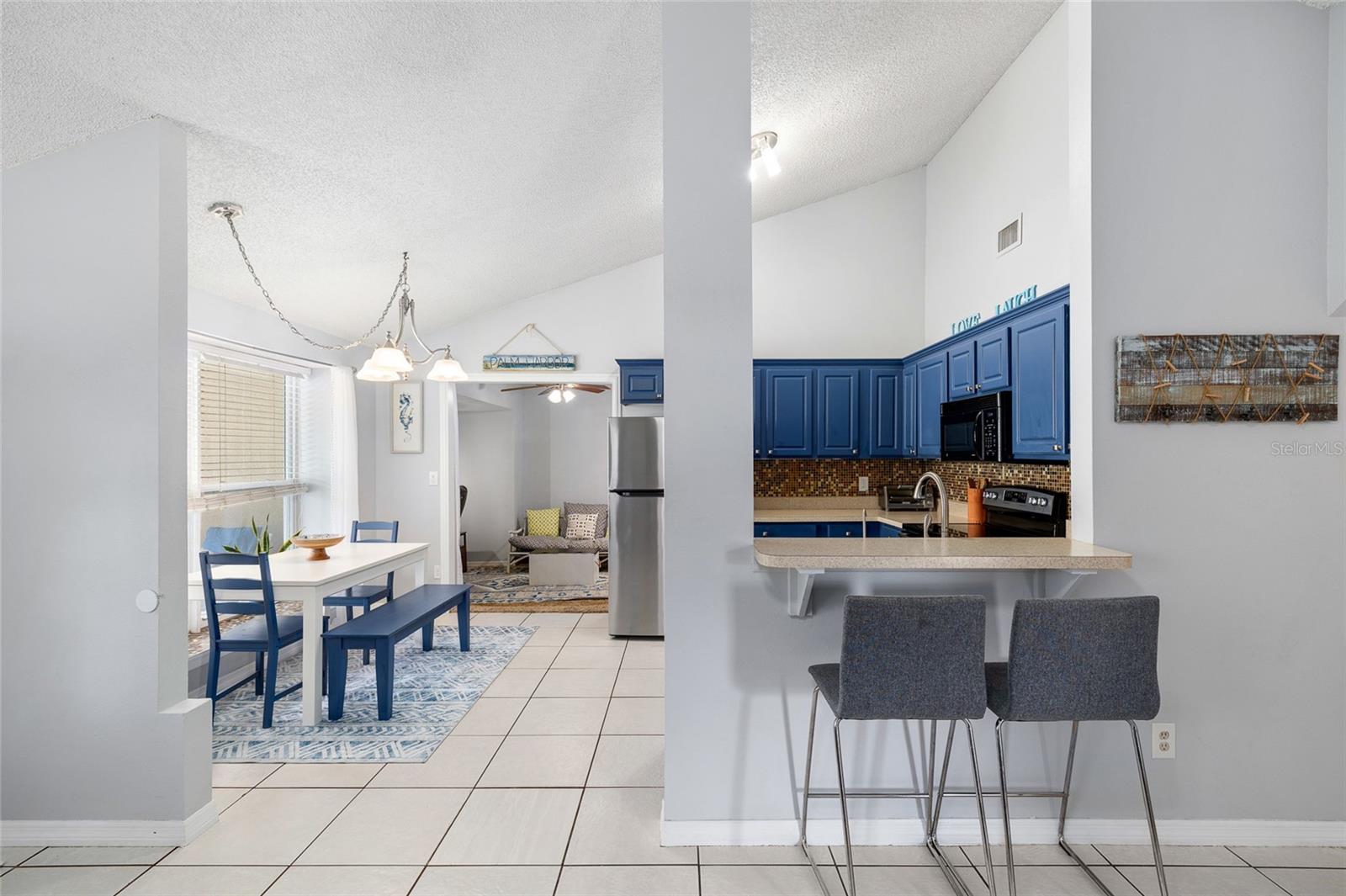 Lovely bright kitchen with vaulted ceiling and breakfast bar