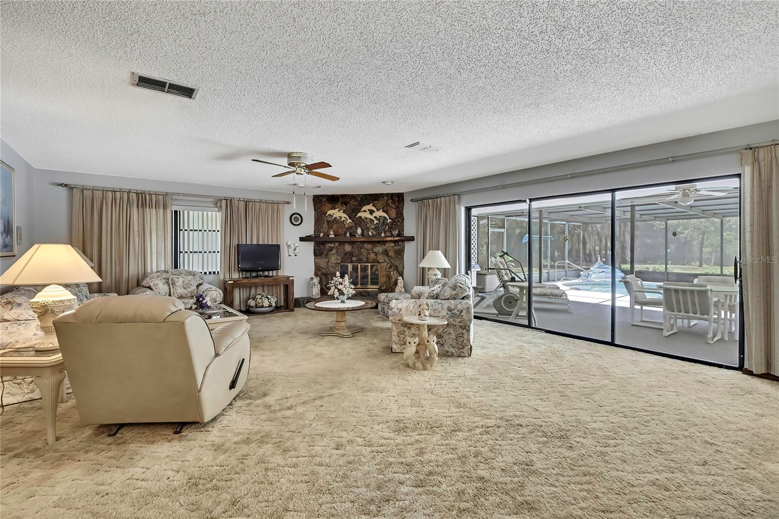 Great room with sliders to pool deck