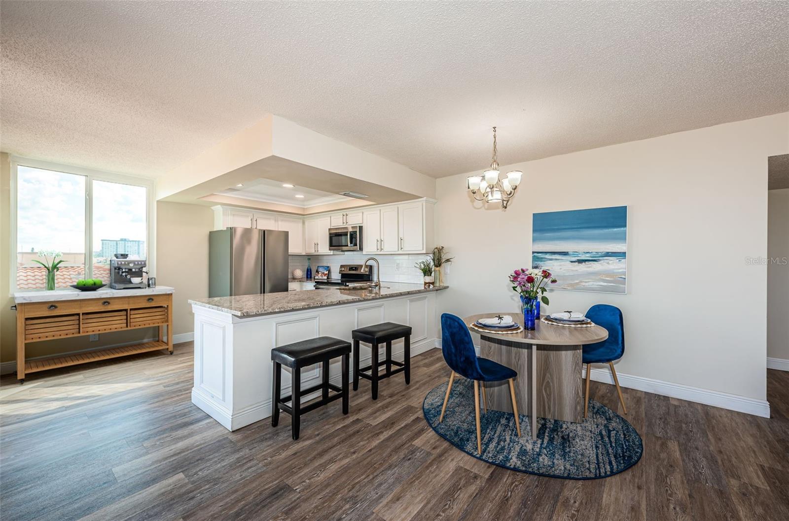 Sleek kitchen with breakfast bar seating for four—perfect for morning coffee or casual meals.
