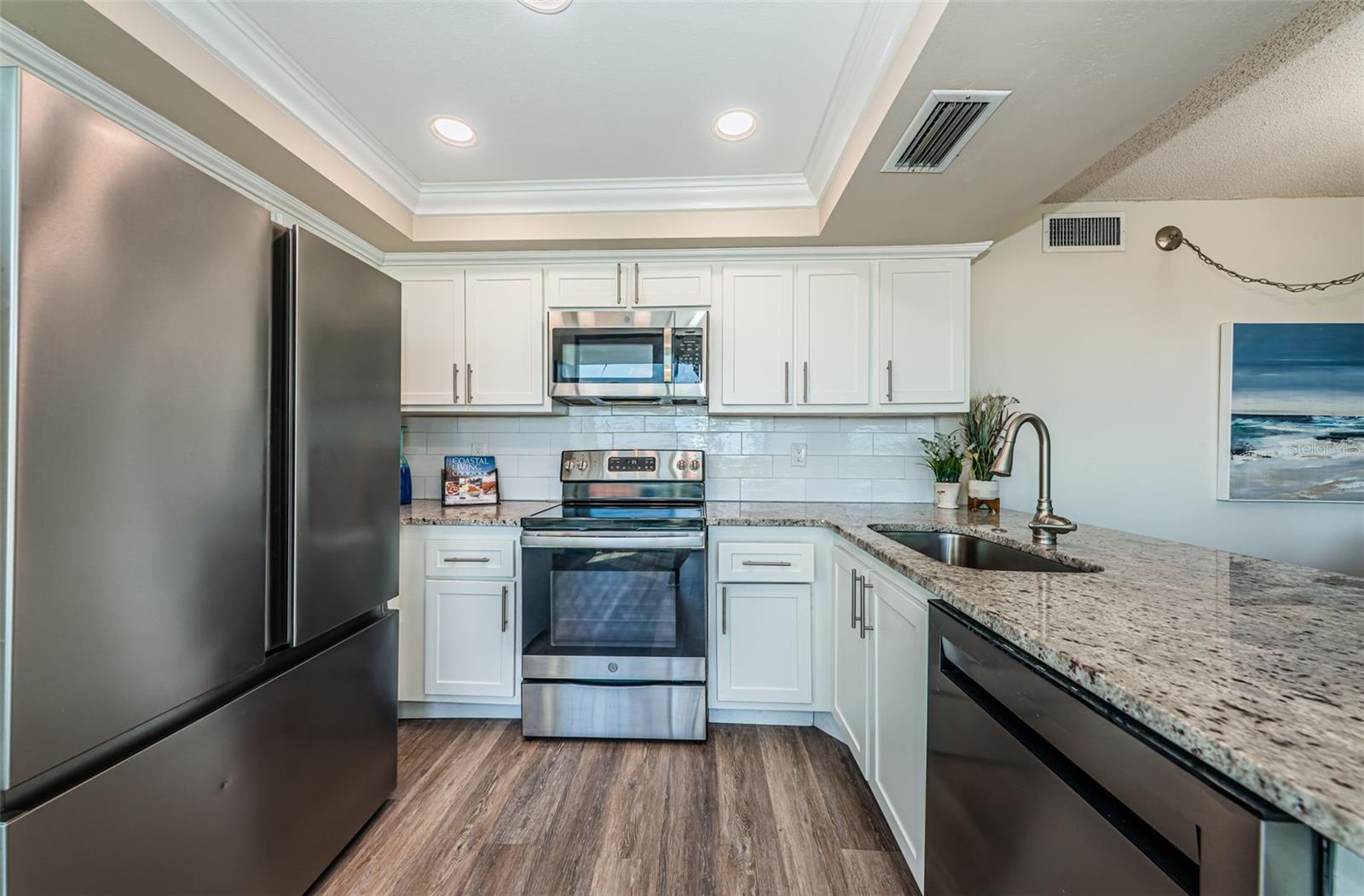 Fully renovated kitchen with quartz counters, stainless appliances, and custom cabinetry.