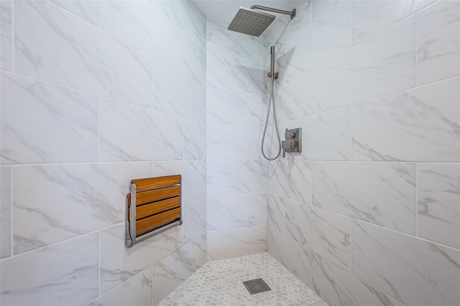 Spa-inspired primary bath with walk-in tiled shower and modern vanity (2024 update).