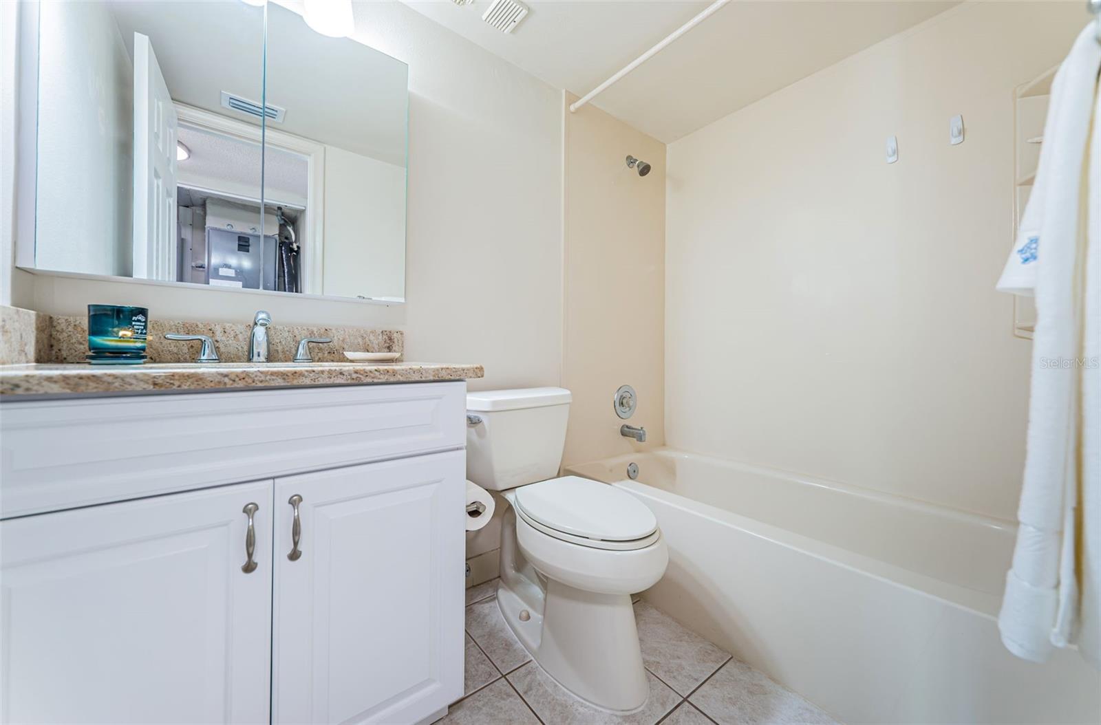 Guest bedroom with privacy and access to a full hallway bath.