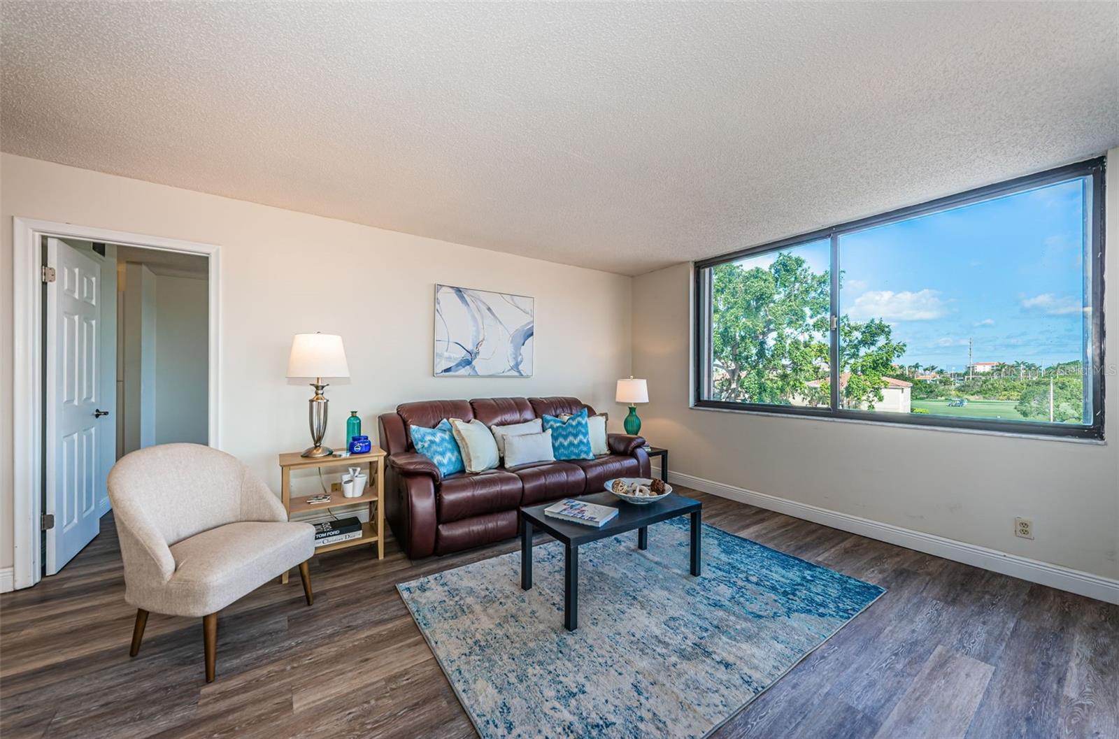 Sun-drenched open living space with modern floors and a seamless indoor-outdoor feel.