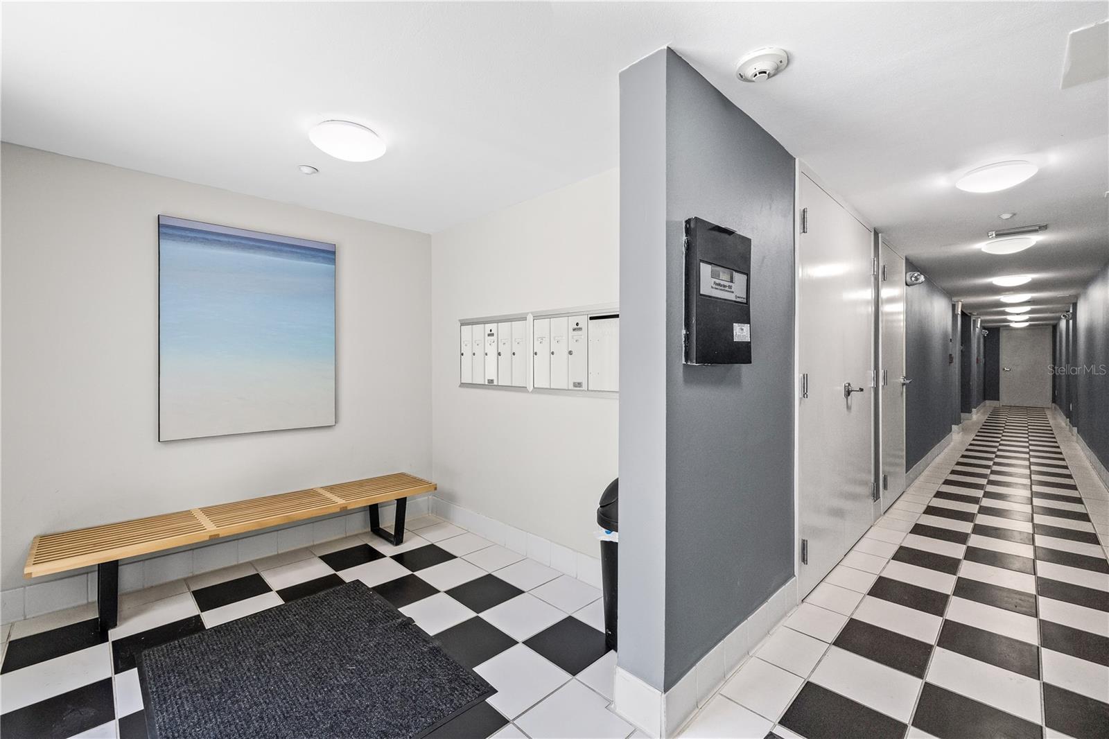 Lobby to hold packages and hall to the elevator, garage and storage room.