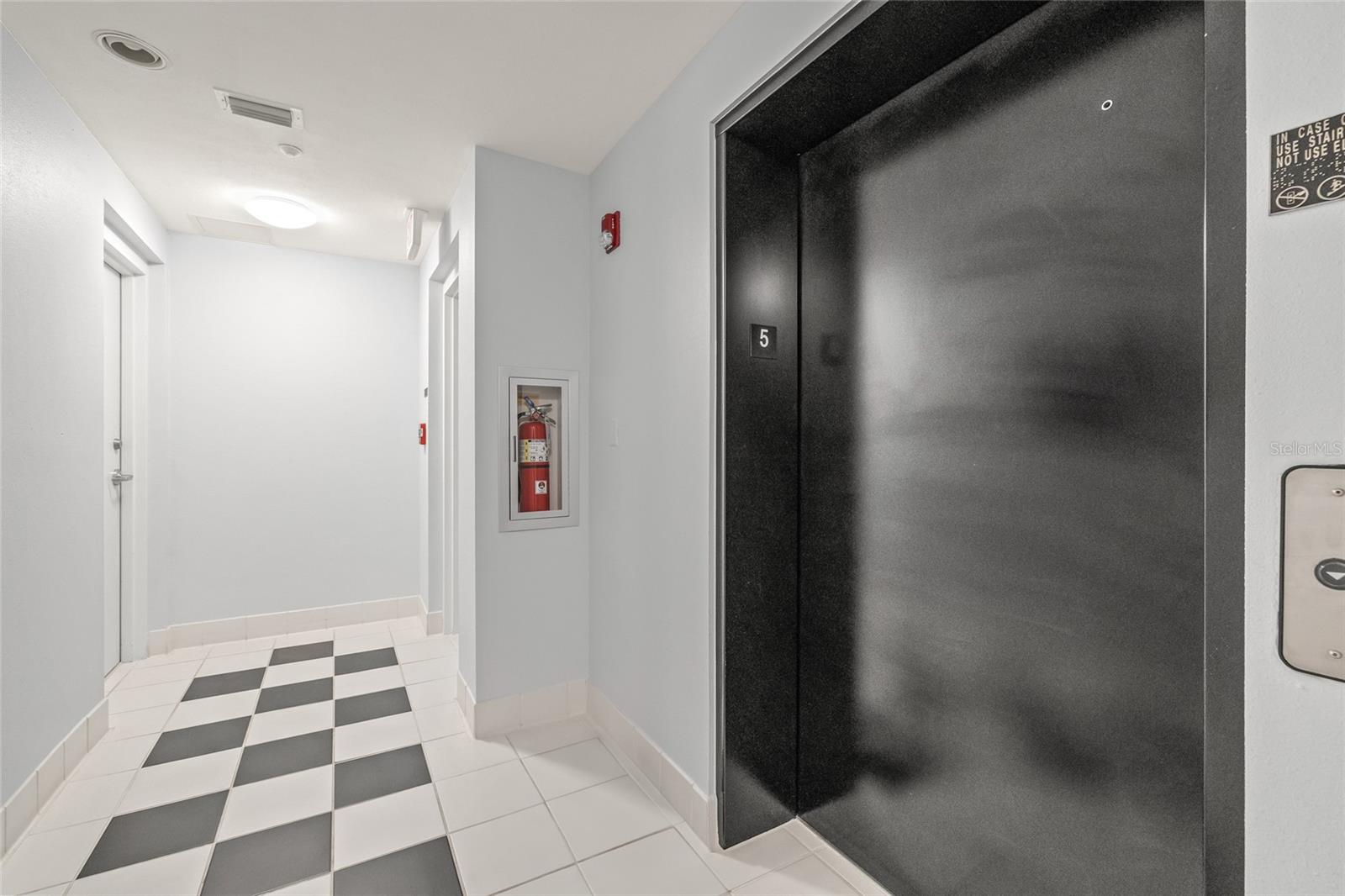 The unit is steps away from the elevator and directly across from the stairwell.