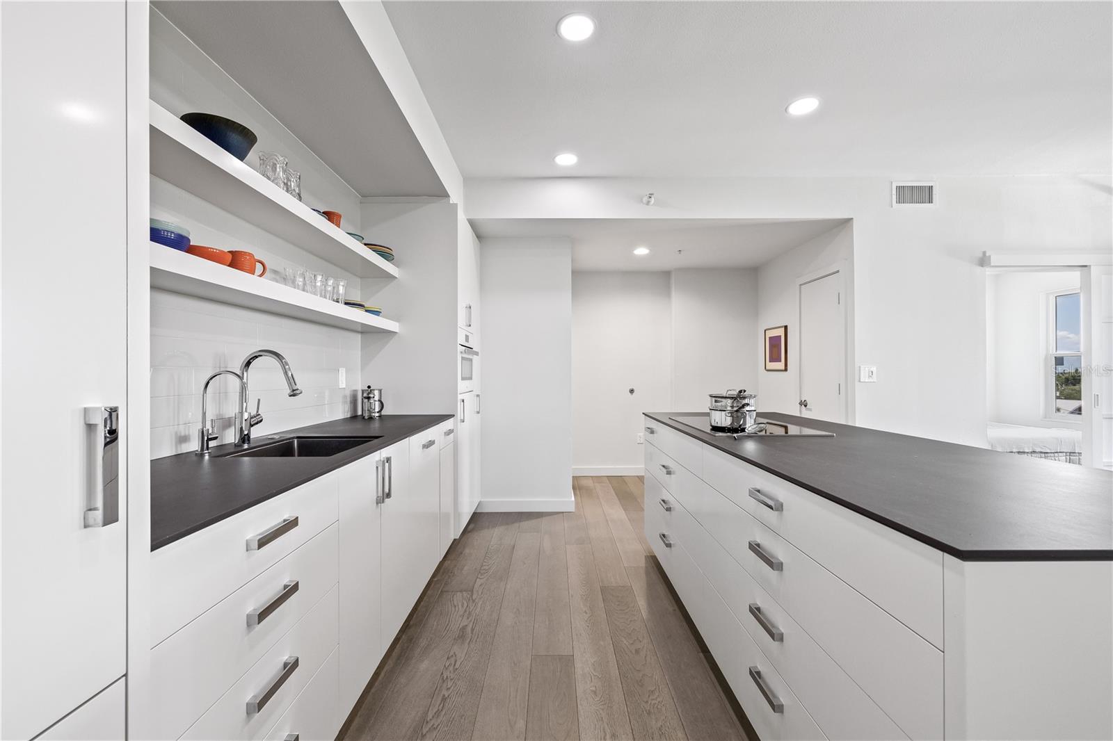 Deep drawers and elite Miele appliances discreetly blend into the cabinetry.