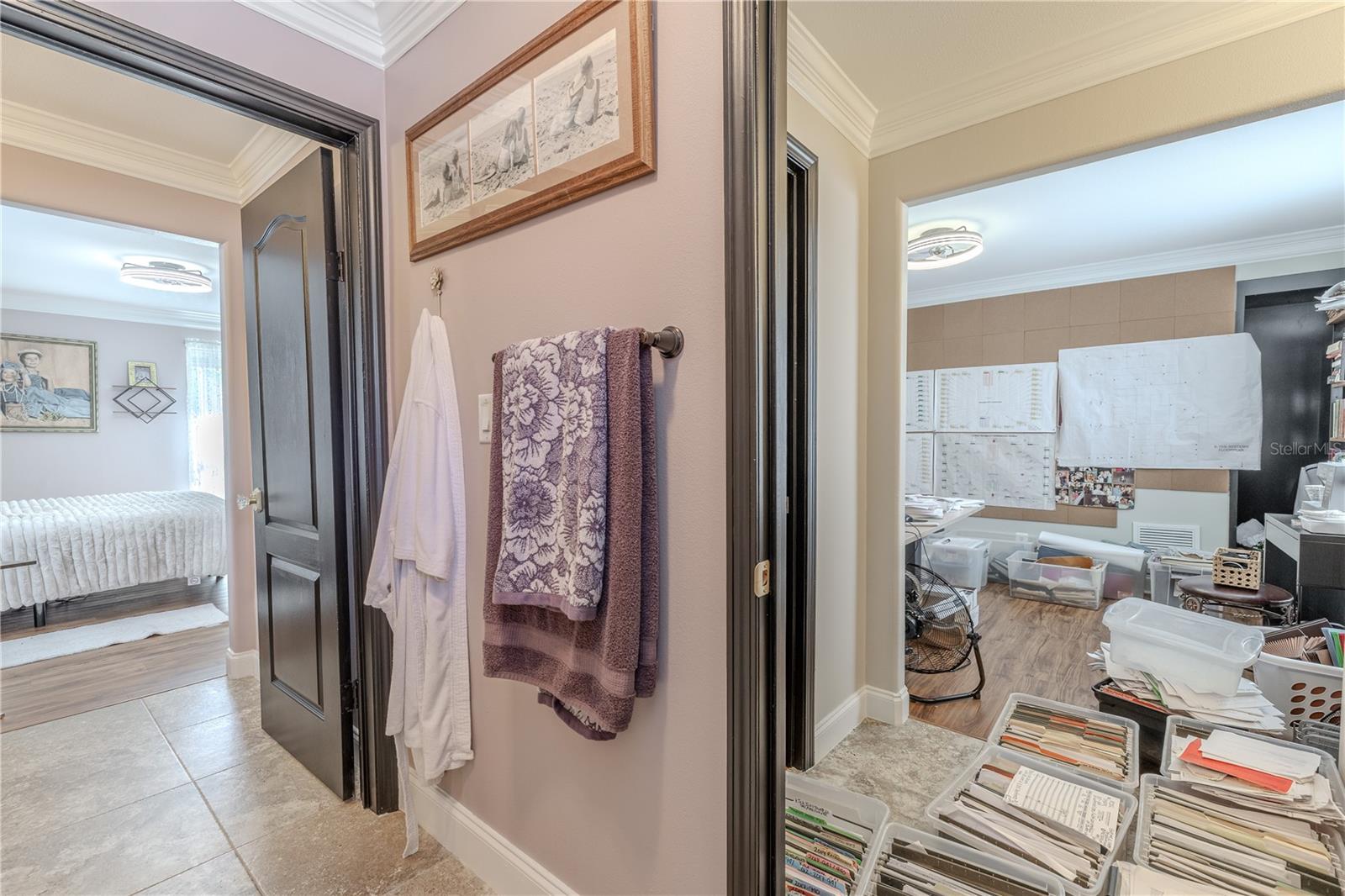 This thoughtfully designed upstairs Jack and Jill bathroom offers convenience and privacy with dual access from adjoining bedrooms.The space features a granite-topped vanity with rich wood cabinetry, dual mirrors, and elegant lighting. A separate water closet and shower/tub combination provide practical functionality, making it ideal for sharing. Neutral tilework and crown molding add a polished touch, while the layout ensures everyone has room to get ready in comfort and style.