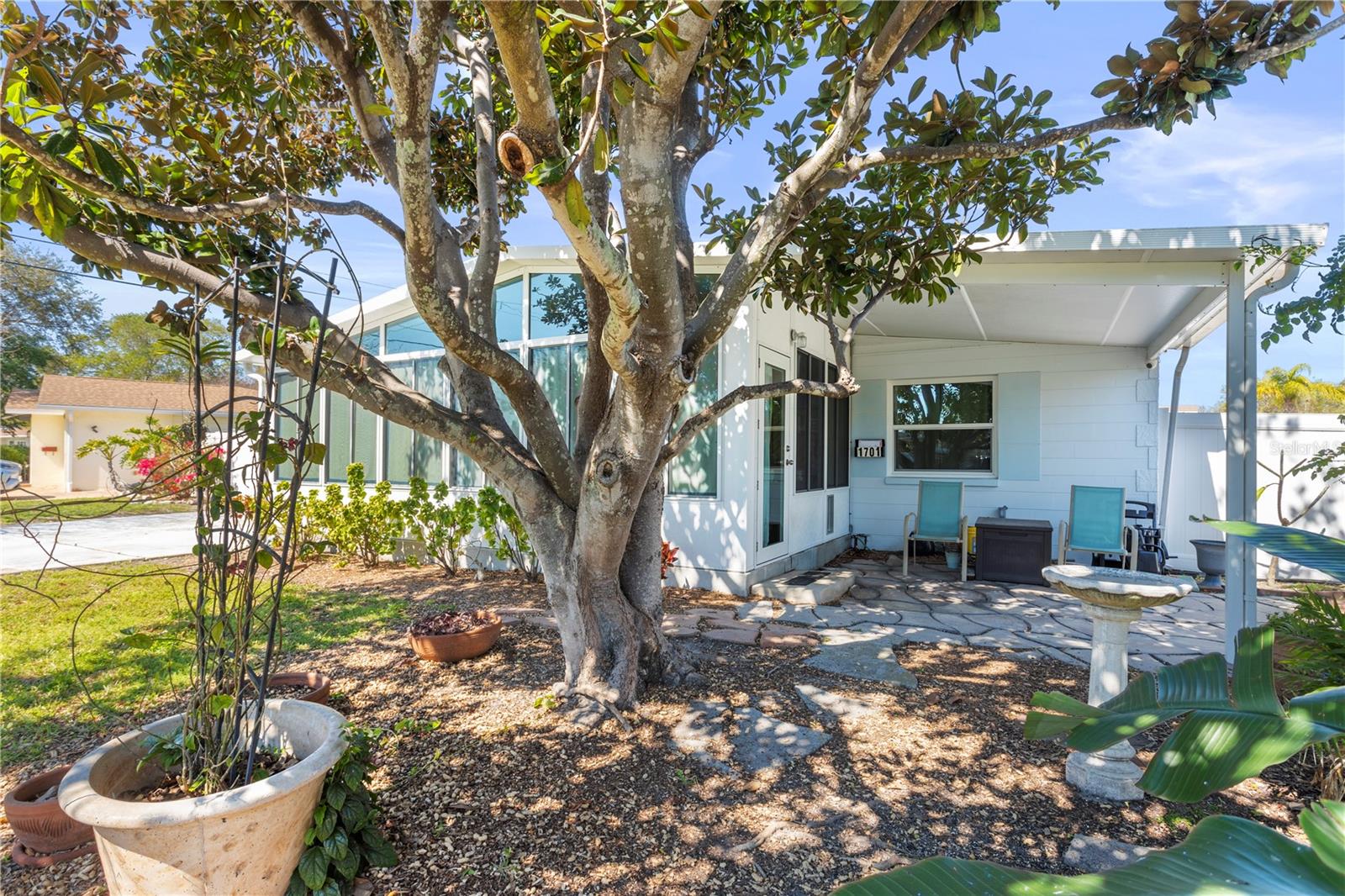 Mid Century home with side porch and large driveway to accomodate at least 3-4 vehicles.