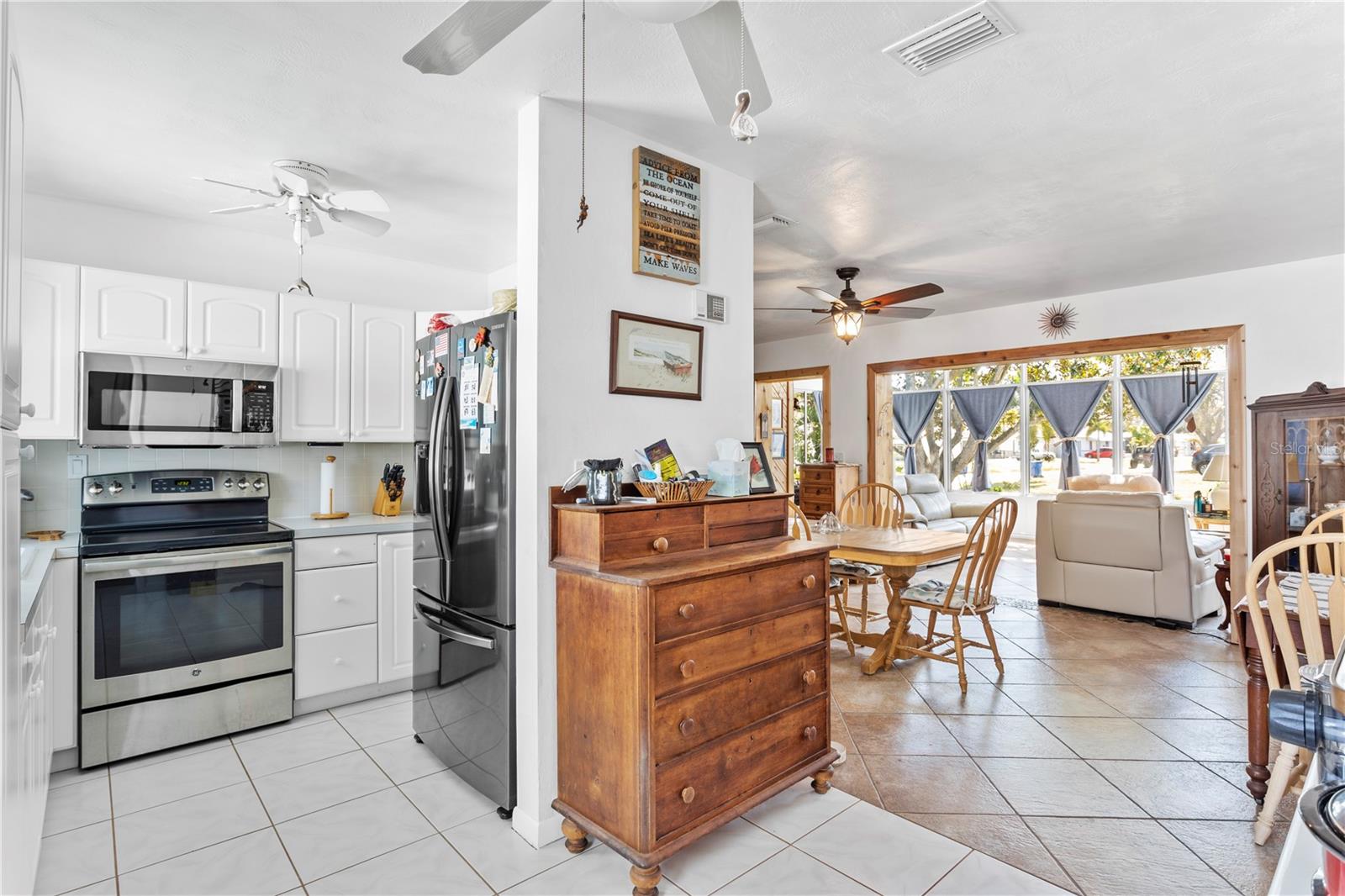 Kitchen is tucked away adjacent to the dining area.
