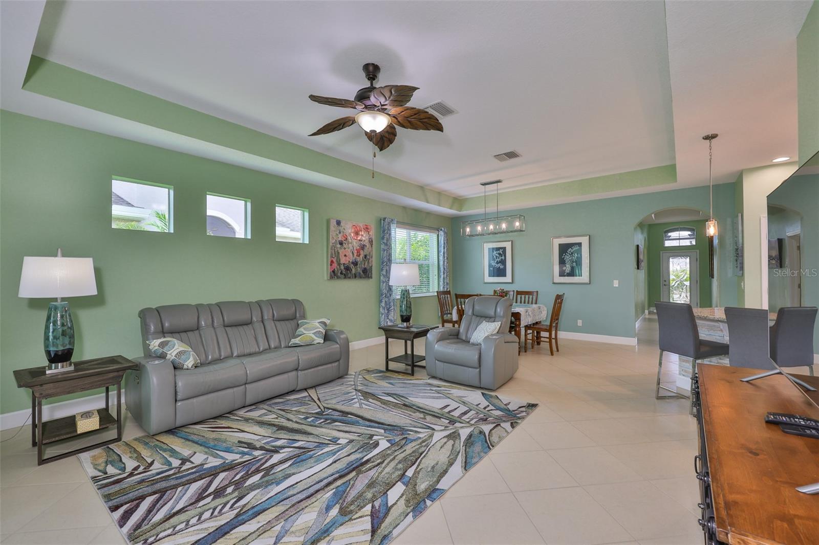 Windows and high ceilings compliment this lovely living space.
