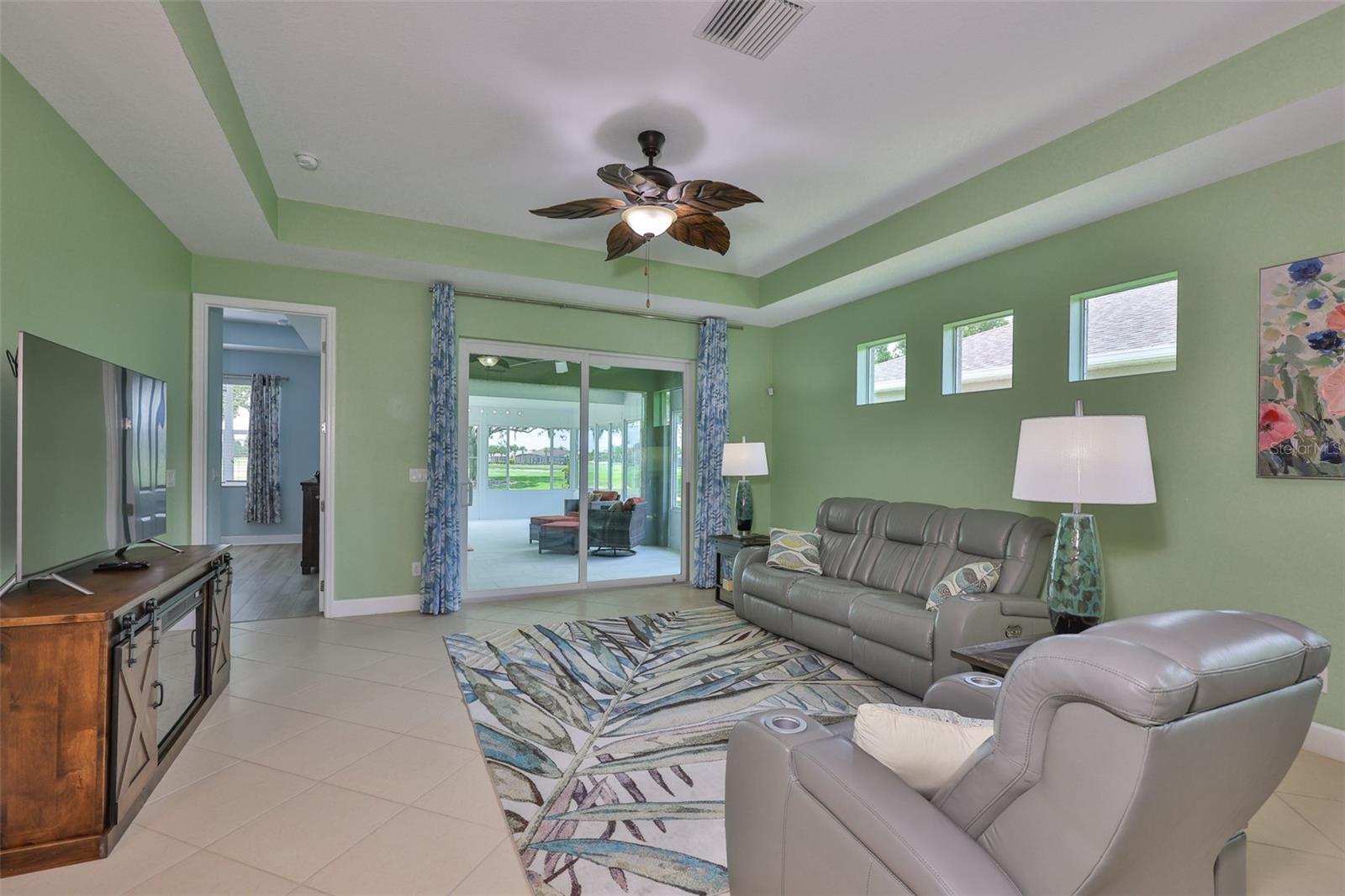 Large 8' sliding glass doors welcome you to the exceptional BRAND NEW Florida Room 27 x 24.