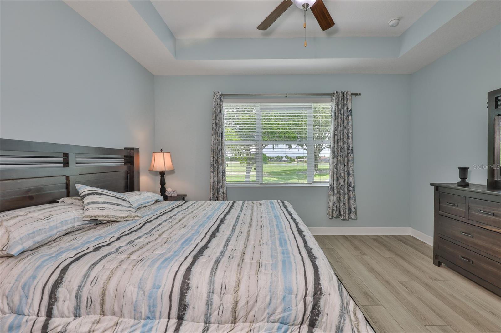 A large three panel window looks out onto the Renaissance Golf Course and water view.