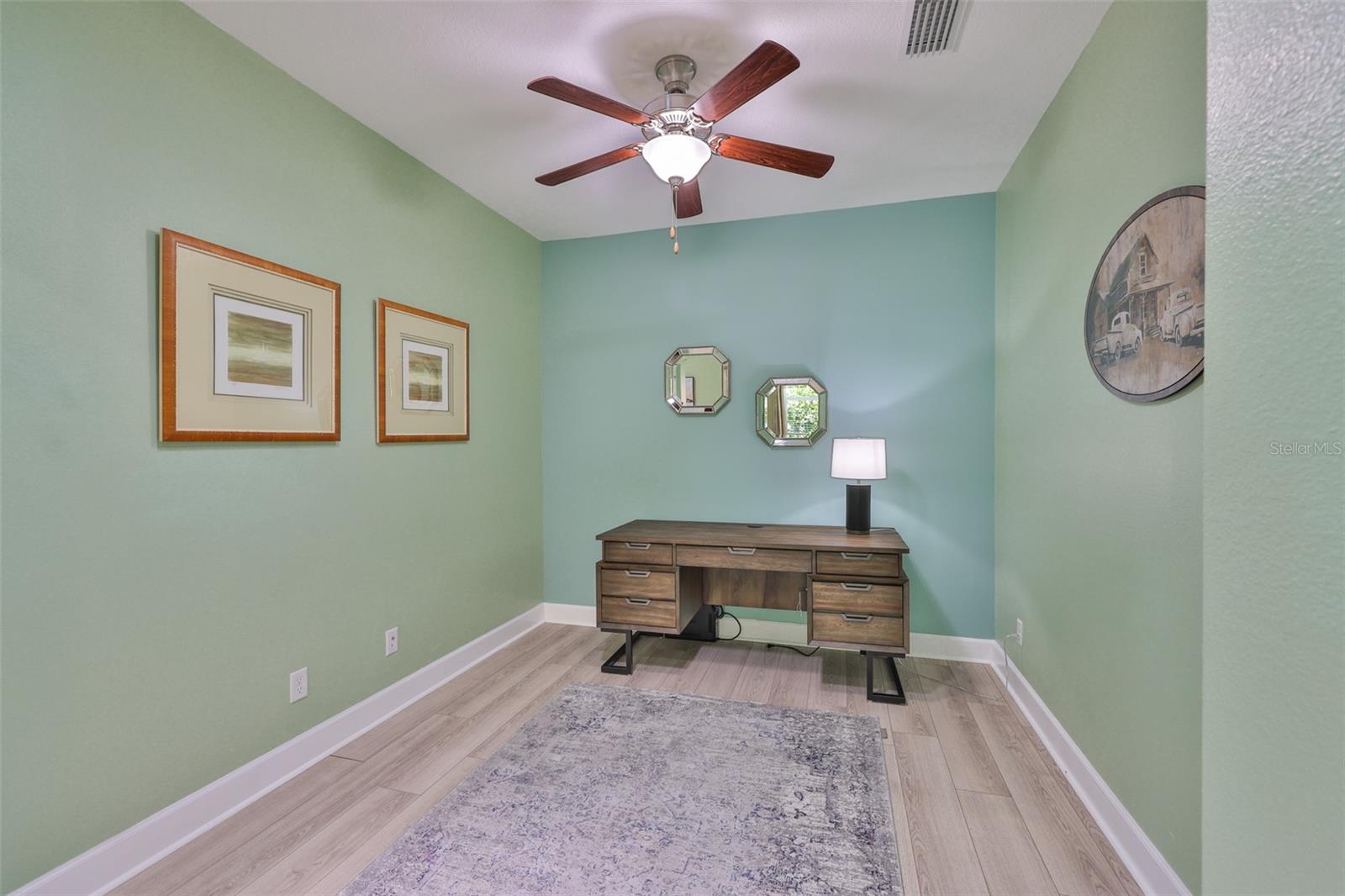 Office/Den is perfect for a wide variety of uses with its soft paint tones, ceiling fan and clean lines.