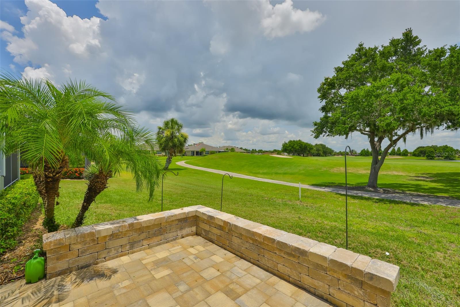 Step outside of the Florida room, onto the custom pavered, open air patio.