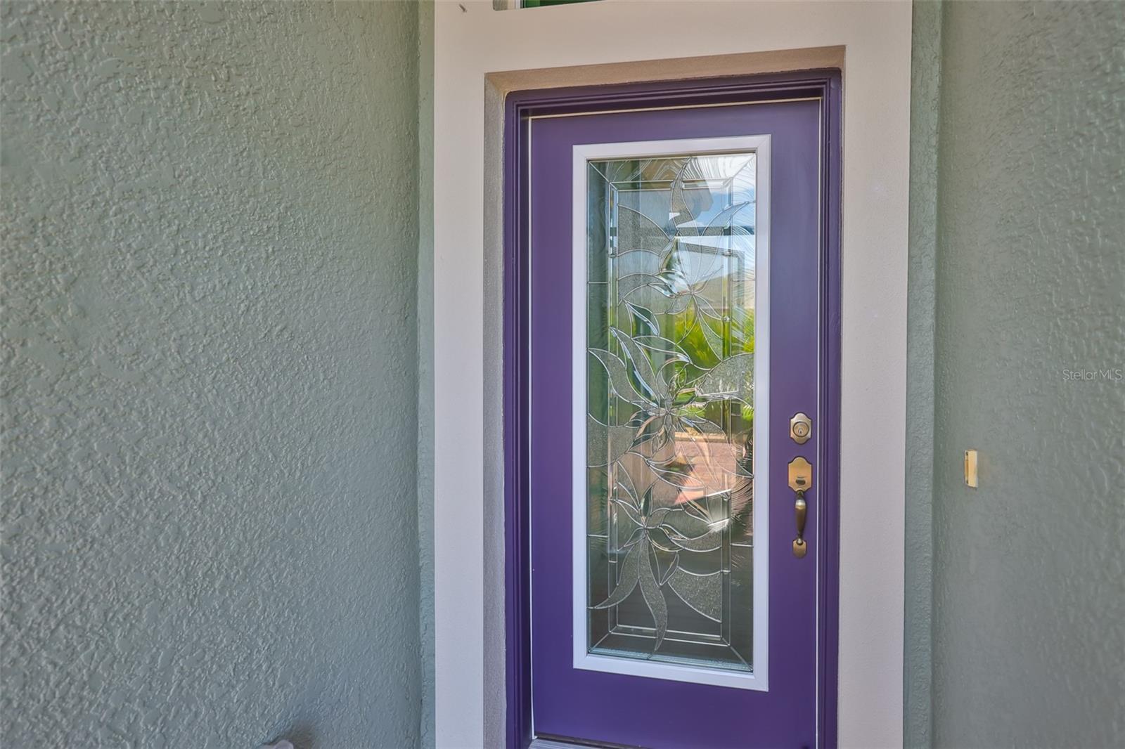 Beautiful custom glass front door, HURRICANE RATED allows lots of natural Florida sunshine into the home.