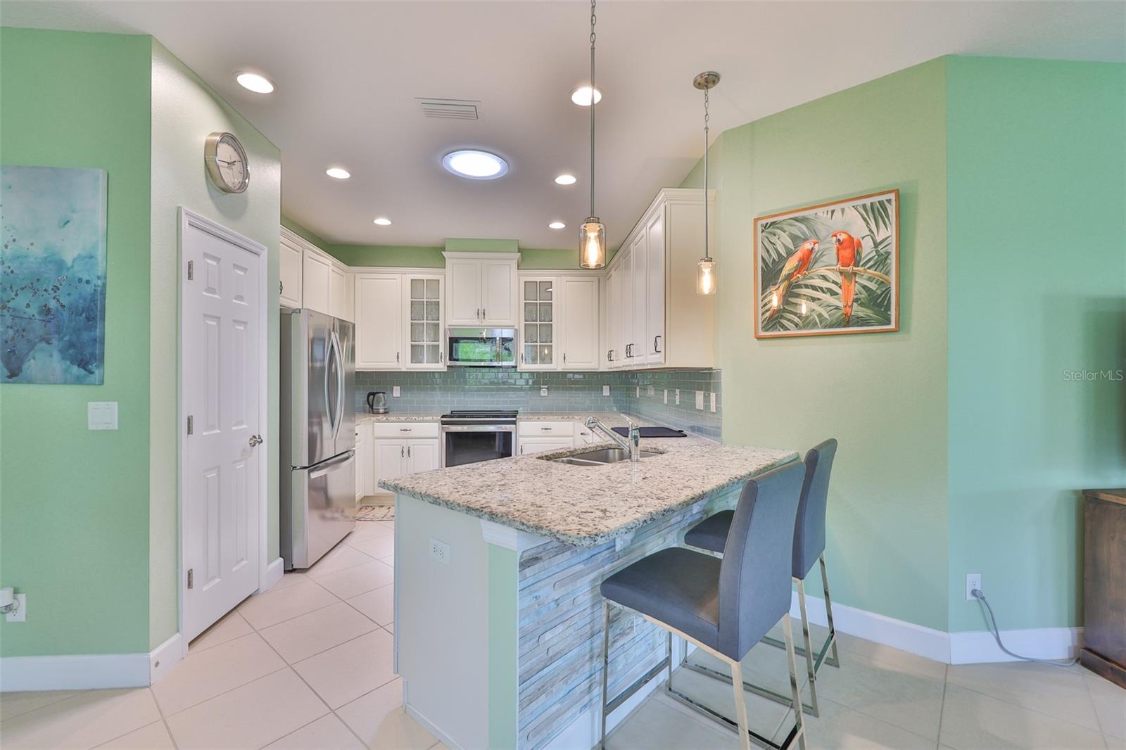 The kitchen is clean, spacious and bright.  White all wood cabinets, granite countertops and a large pantry accent this beautiful room.