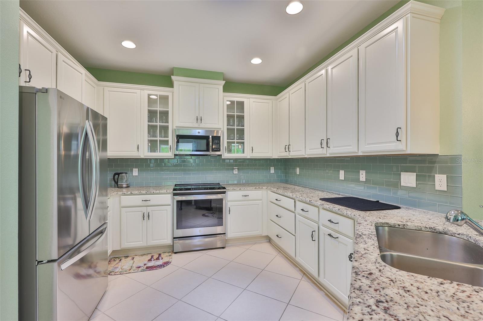 High end stainless appliances compliment the endless cabinetry.  Drawers, lighted cabinets and even concealed trash bins have all been thoughtfully included.