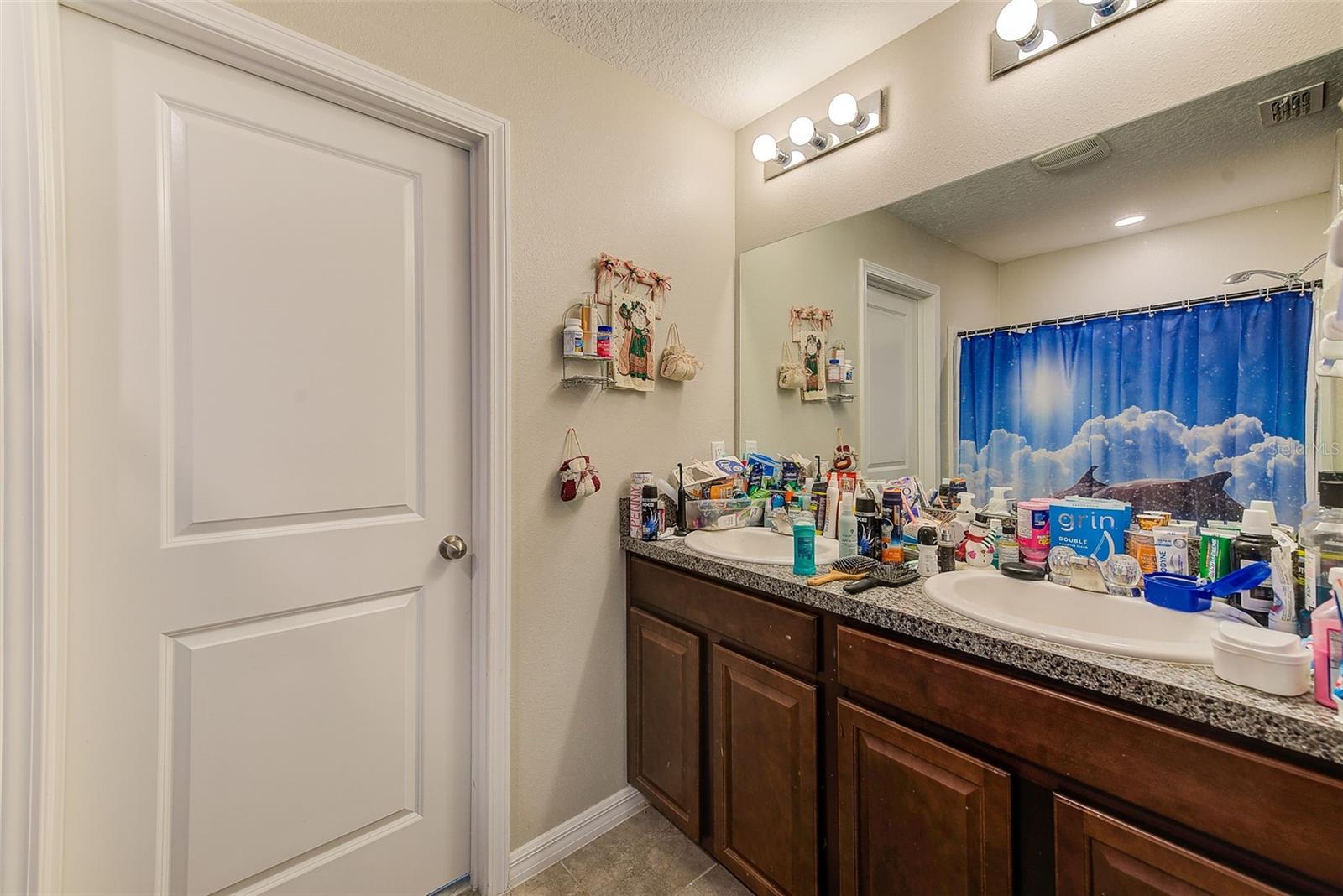 Primary bath with dual sinks and separate water closet.