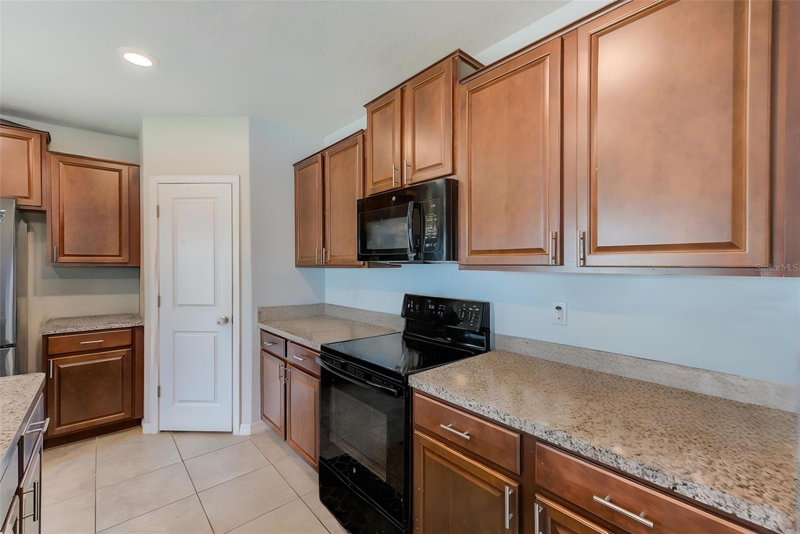 Kitchen with corner pantry.