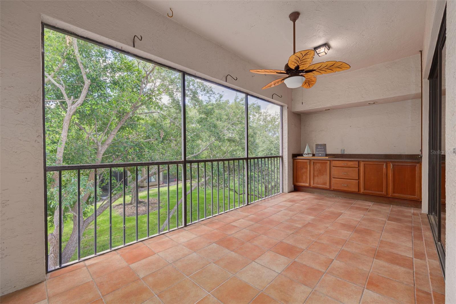 Screened lanai is 22' wide and overlooks trees and woods!