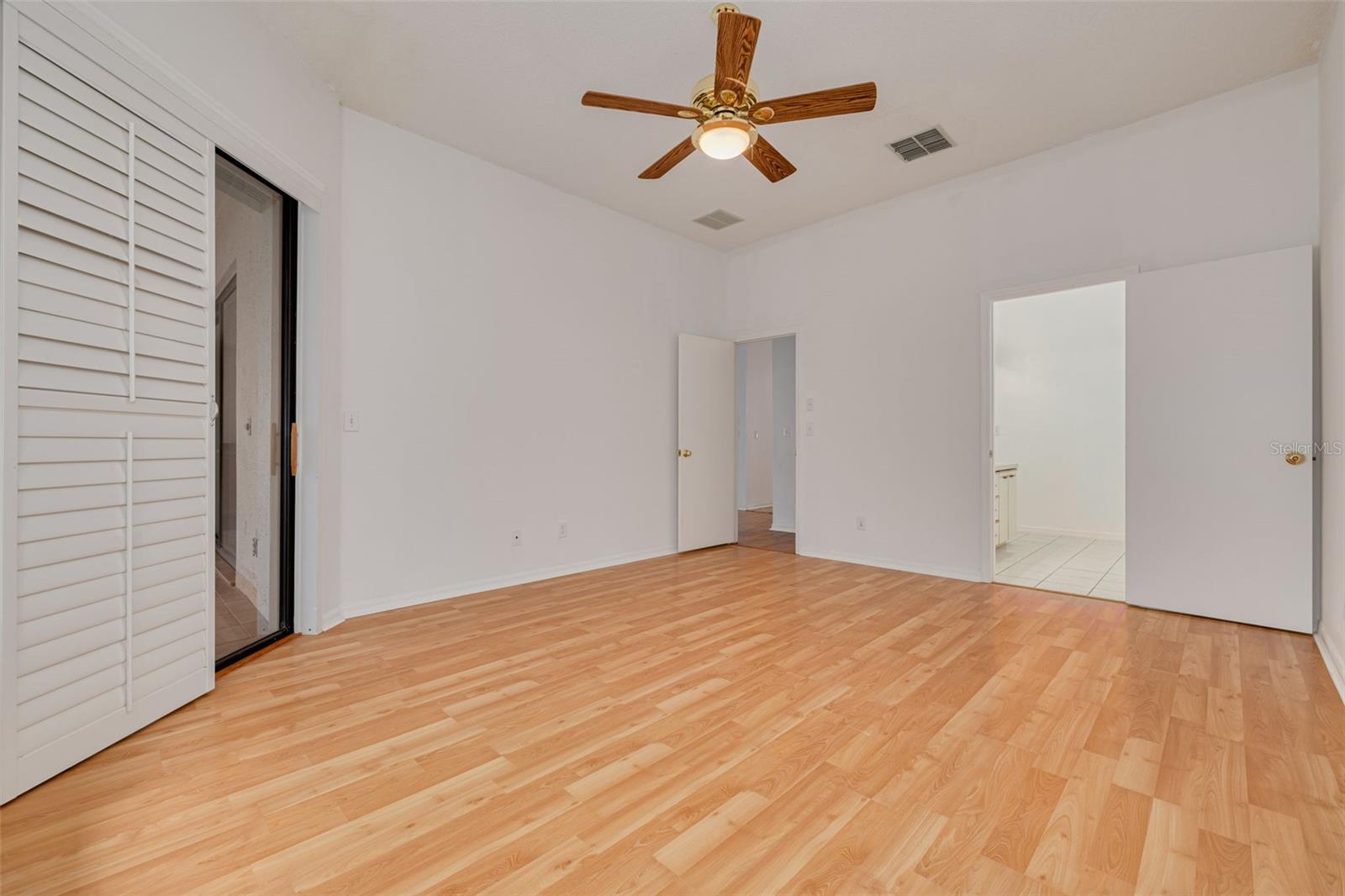 Primary bedroom with slider on left, bathroom on right