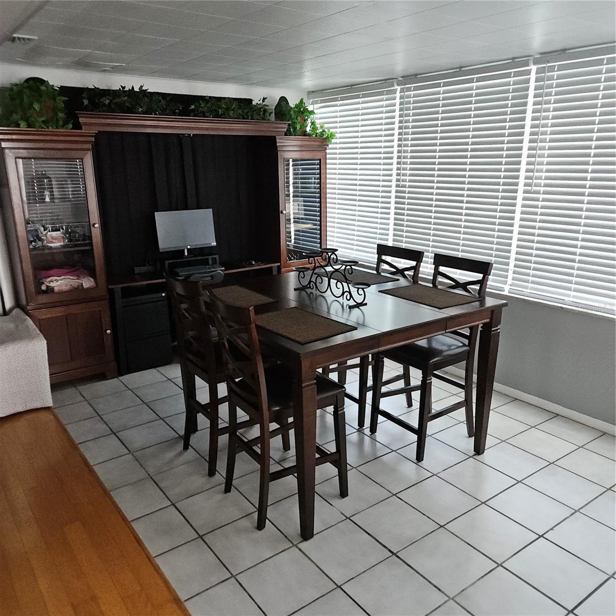Dining Room with Bookshelf covering a curtain that covers the French Doors to the Apartment.