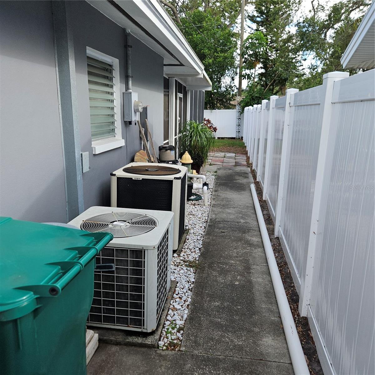 West side of home with AC and Pool Pump