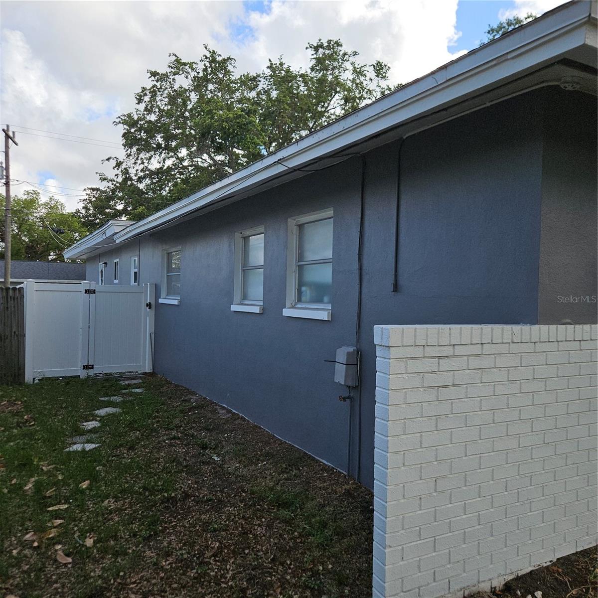 East side of the home showing gate to Apartment