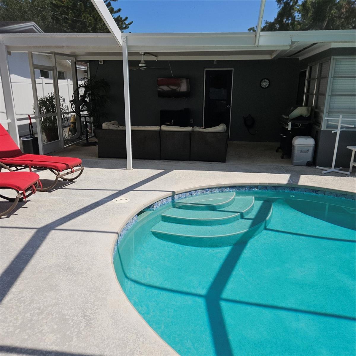 Patio and Pool with plenty of deck for chairs.