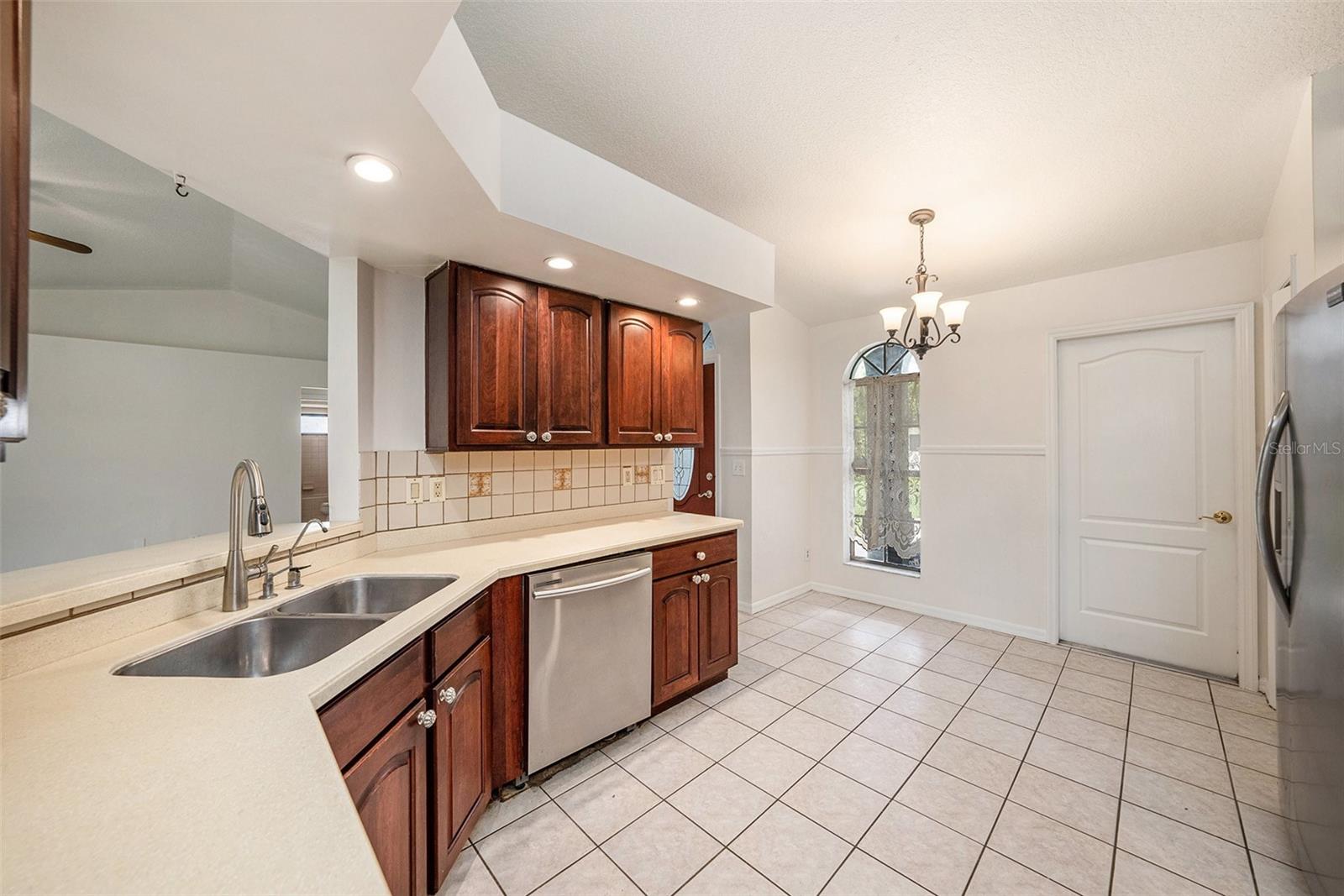 Kitchen has small nook for eating by front window
