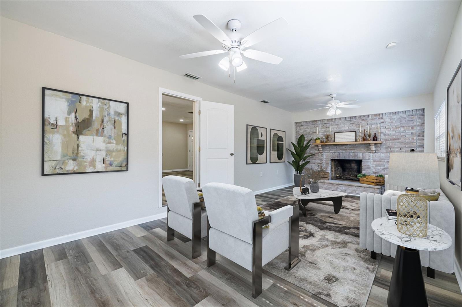 Cozy living room featuring a classic wood-burning fireplace—warmth and charm in every season.*virtually staged
