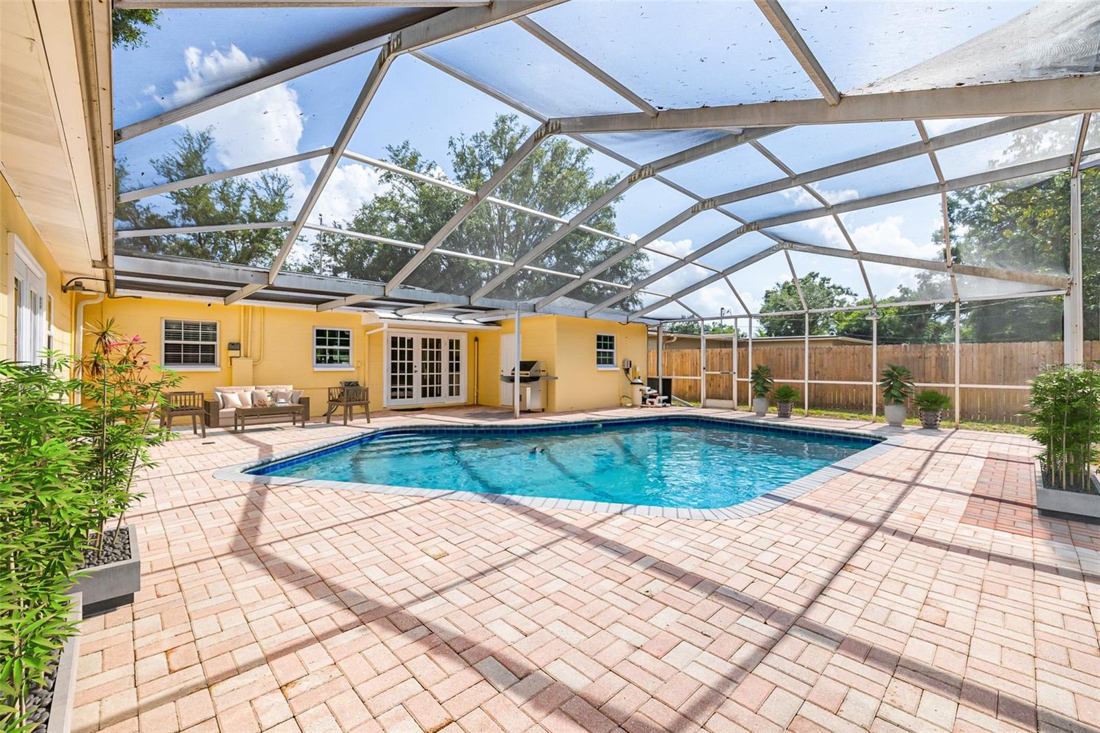 Crystal-clear pool in a private backyard—ready for your personal touch and summer enjoyment.