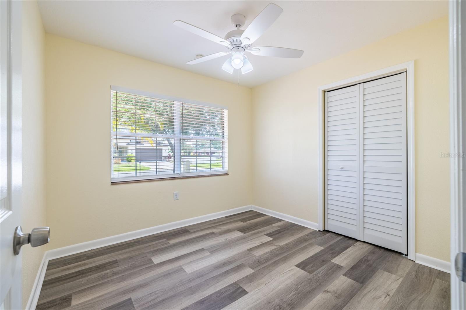 Bedroom 1 overlooks the front of the house and features a ceiling fan and easy-to-use push-up blinds for comfort and convenience.