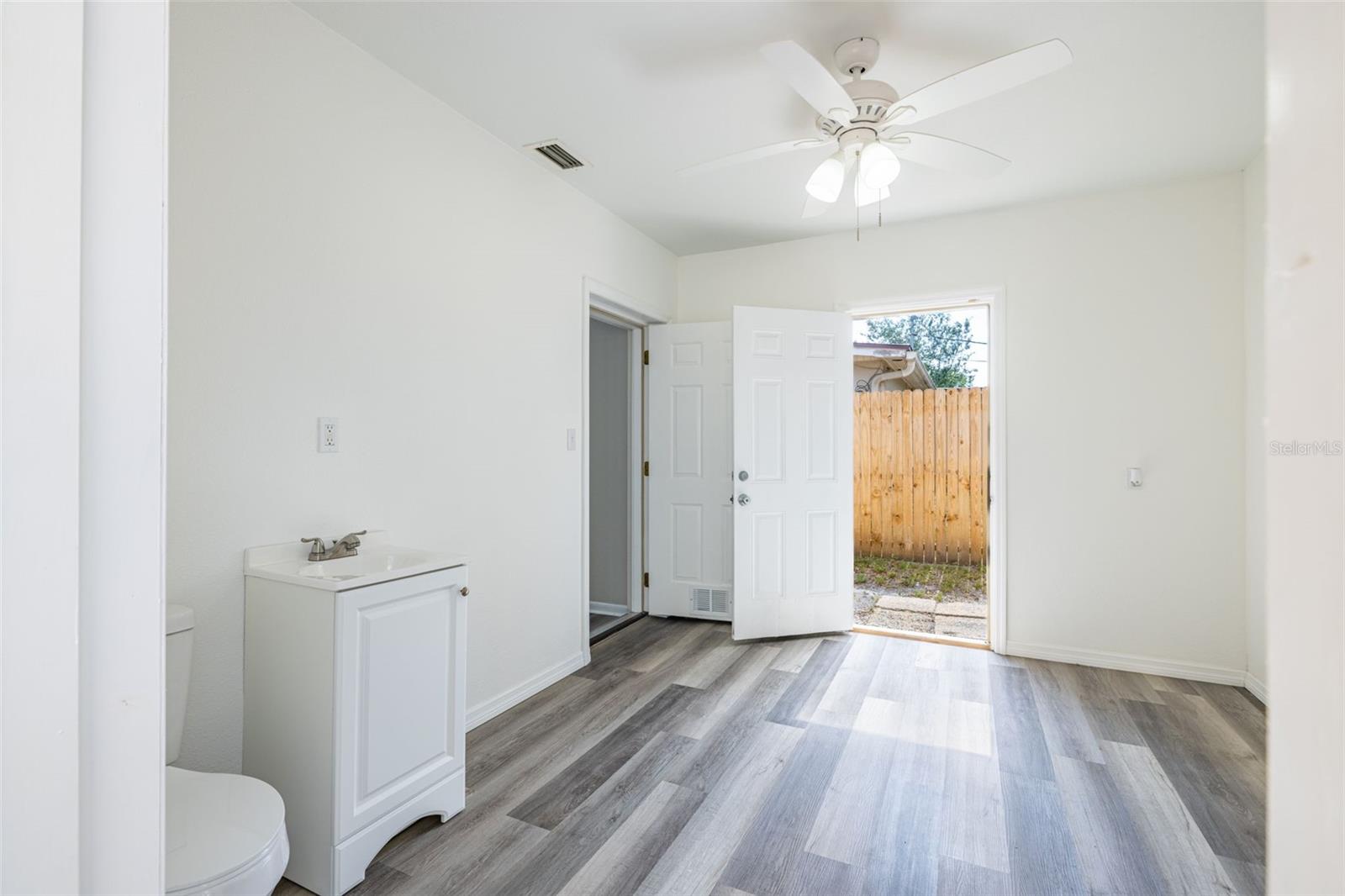 A convenient half bath off the living room provides easy access to the side yard and pool area.