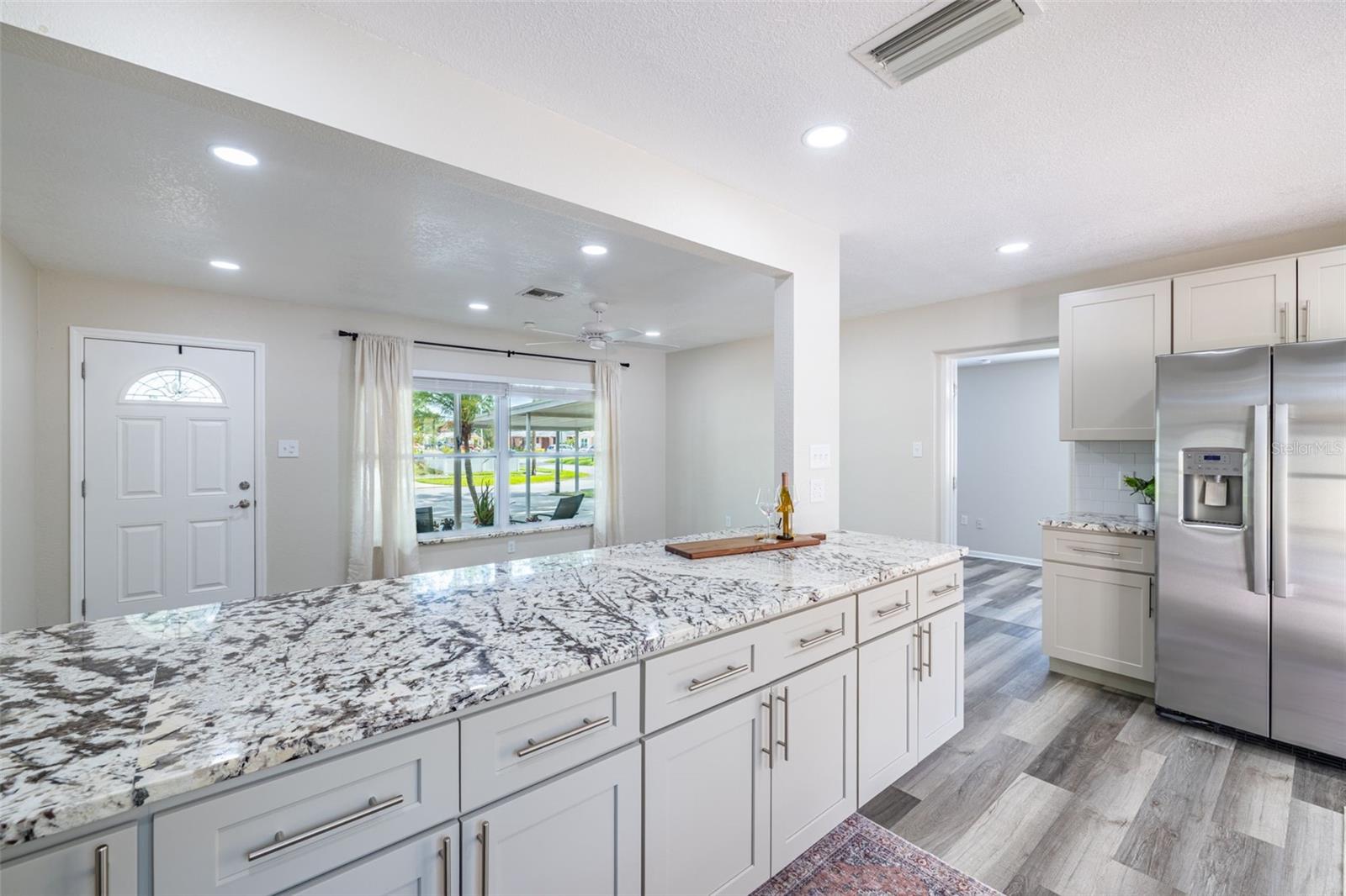 A huge kitchen island offers ample space for seating and socializing — the perfect centerpiece for gatherings and everyday living.