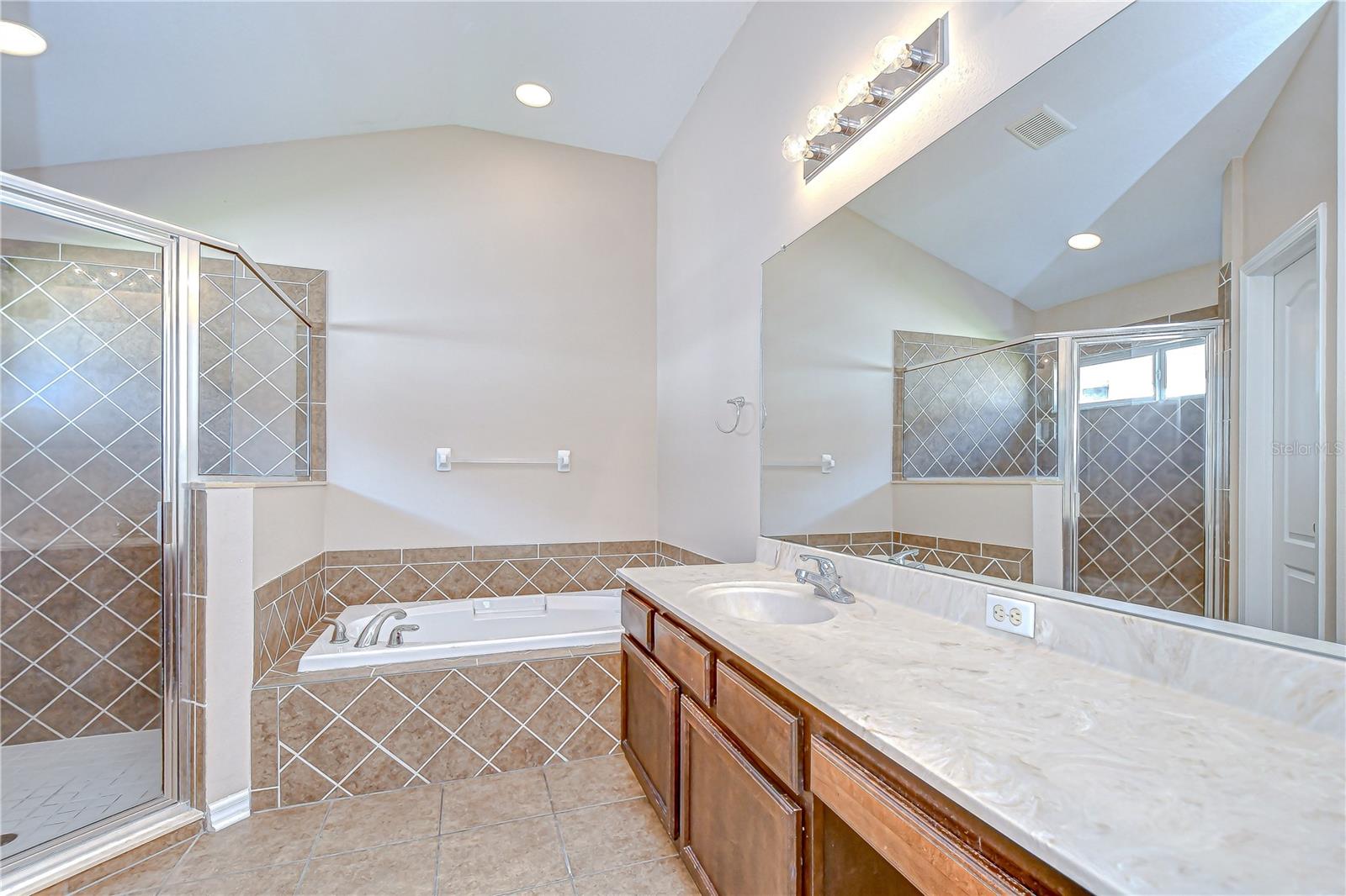 Primary en-suite bath has a walk-in shower and soaking tub!