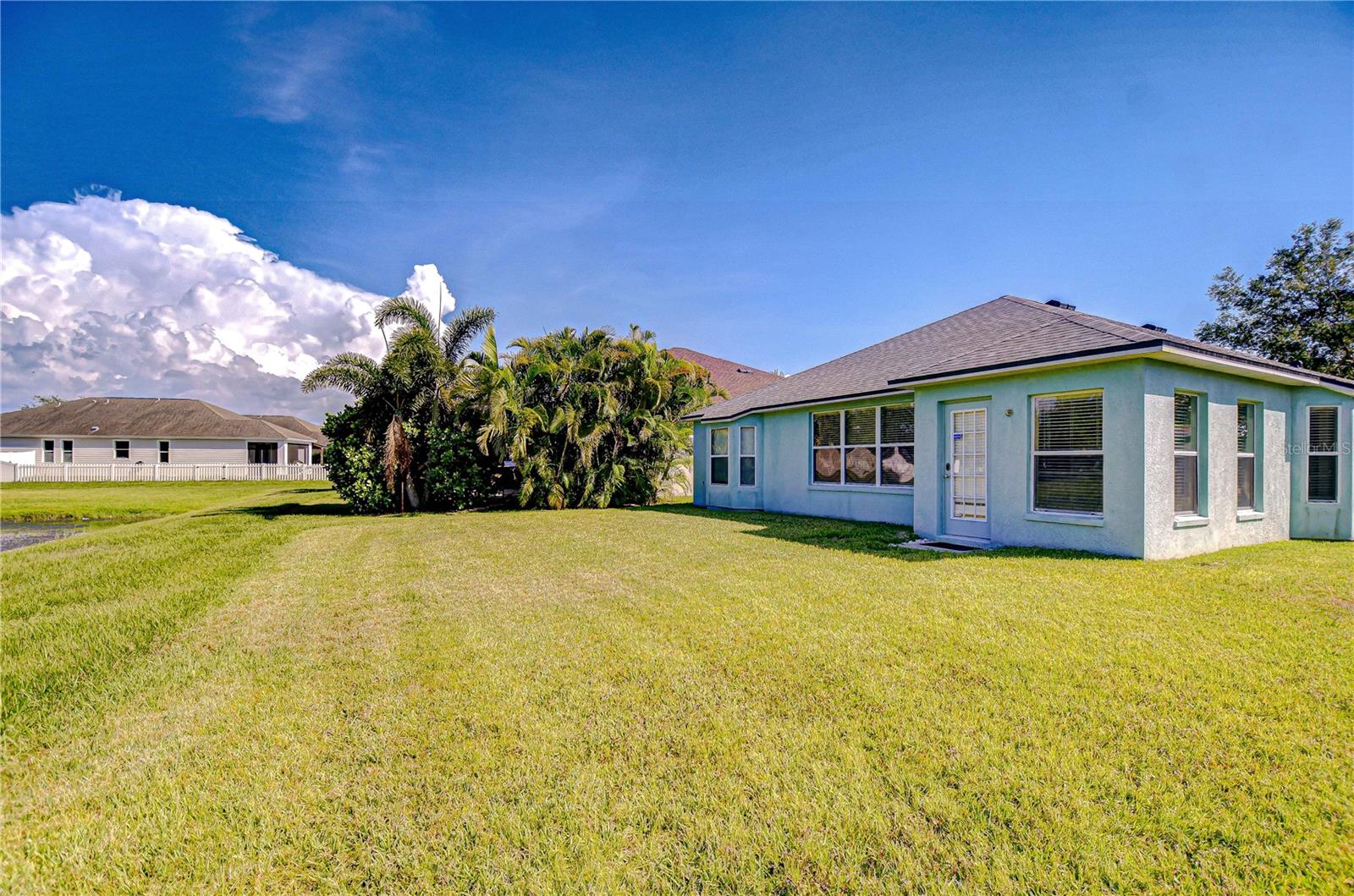 Backyard bliss with open green space!