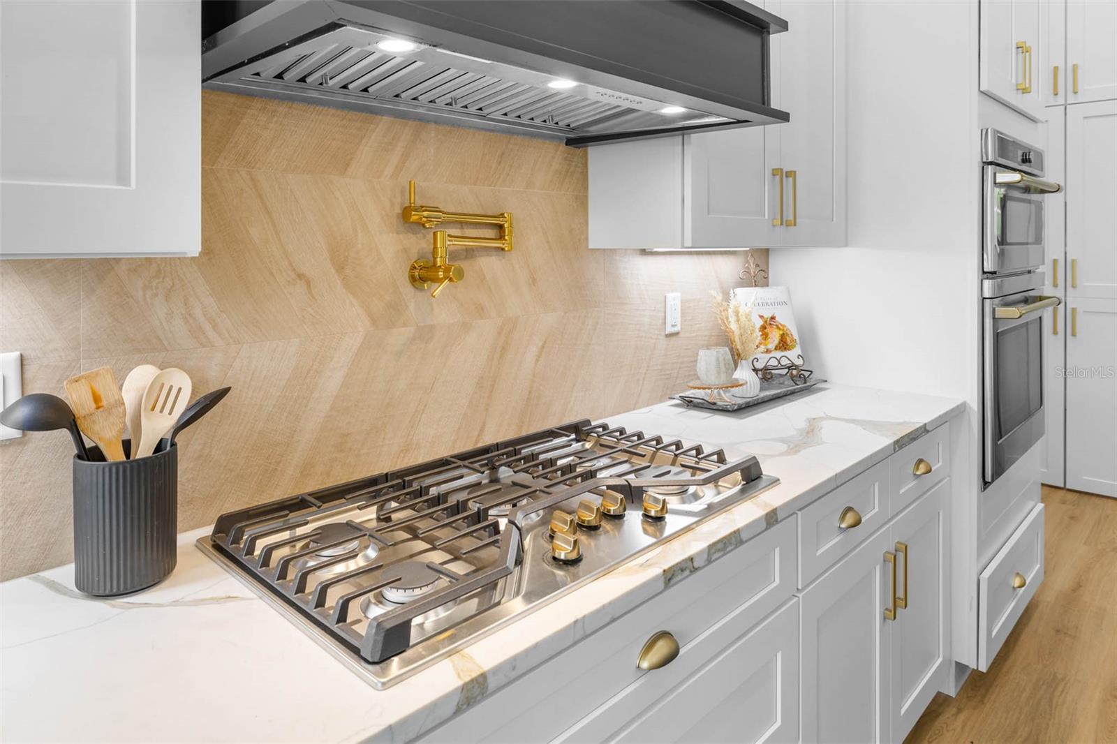 Gas stove top with pot filler