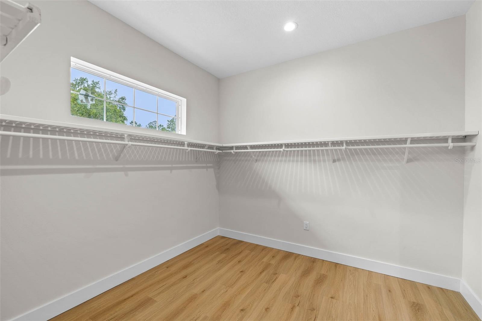 Primary walk-in closet with Custom Shelves