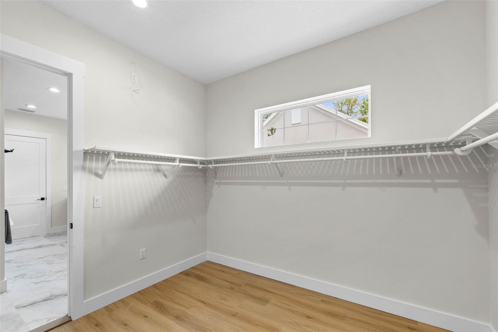 Primary walk-in closet opens to the laundry/mudd room