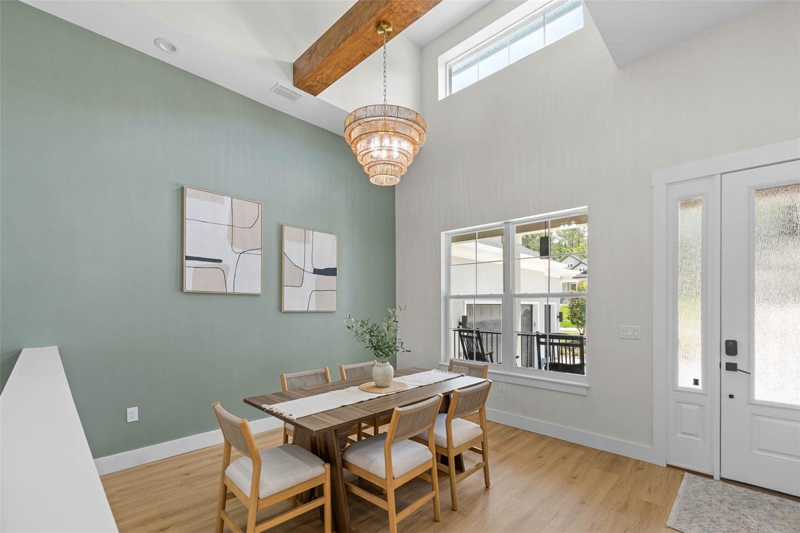 Dining room has an accent wall and exposed beam
