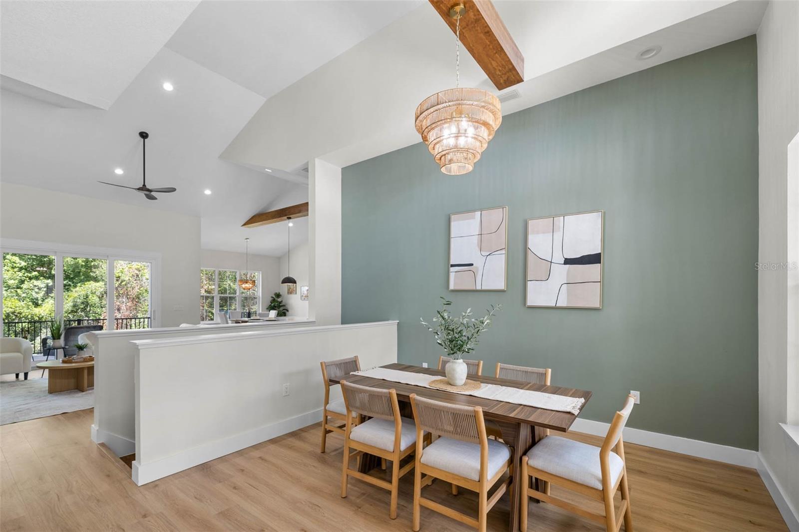 Dining room has an accent wall and exposed beam