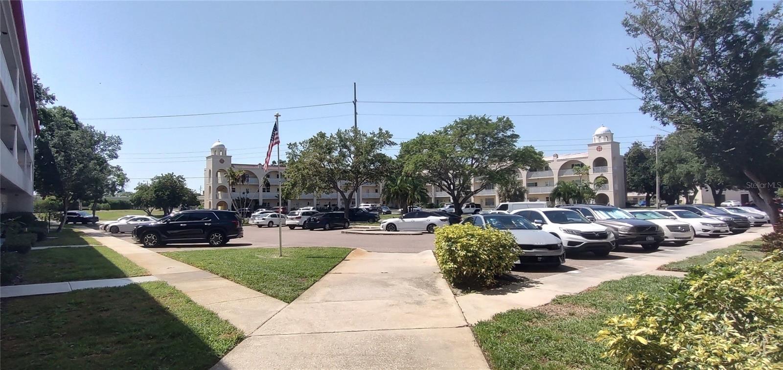 View from other side of building - W side pool to left side of building in front