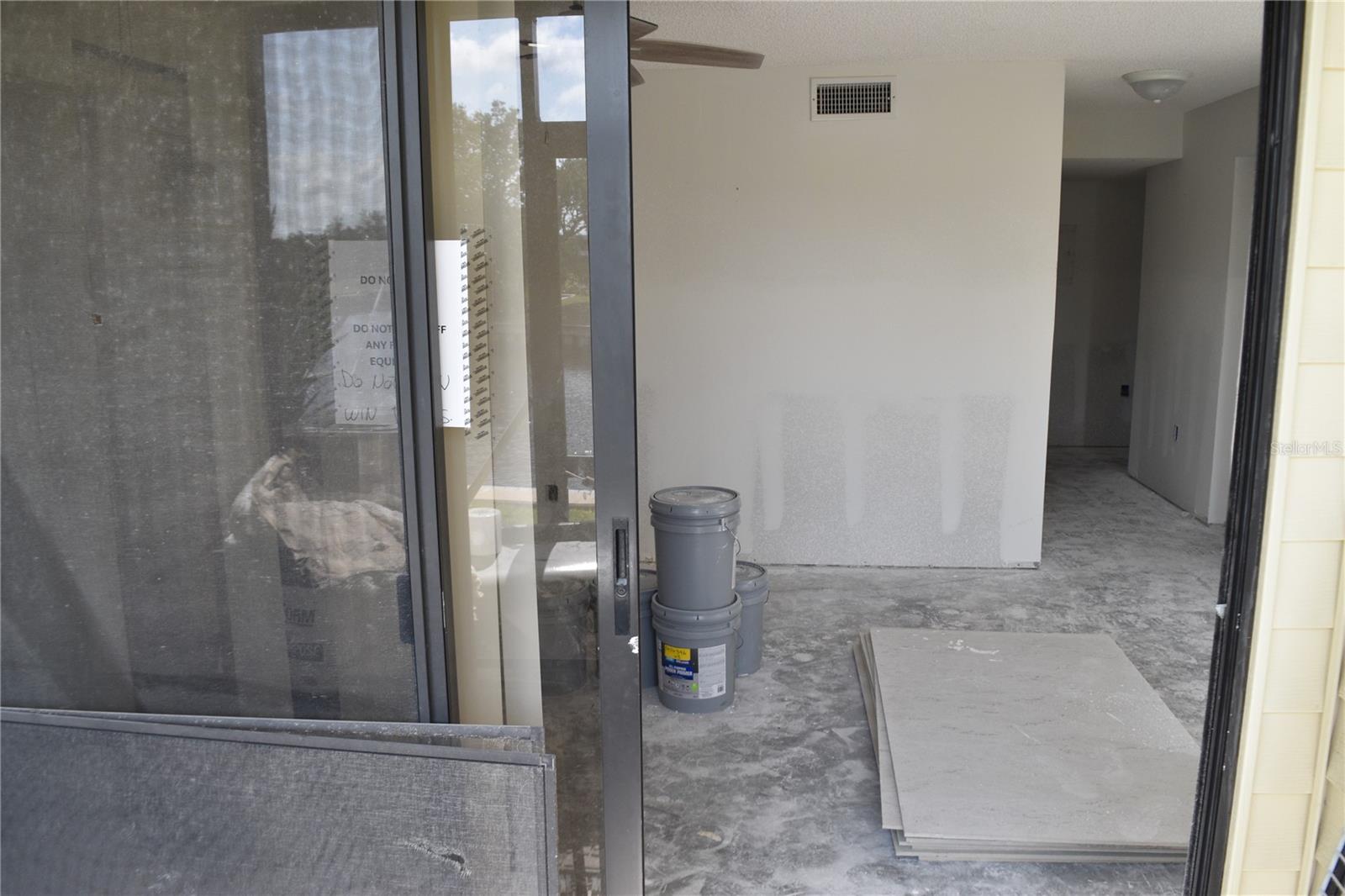 View from screened porch port facing living room and hall to bedrooms
