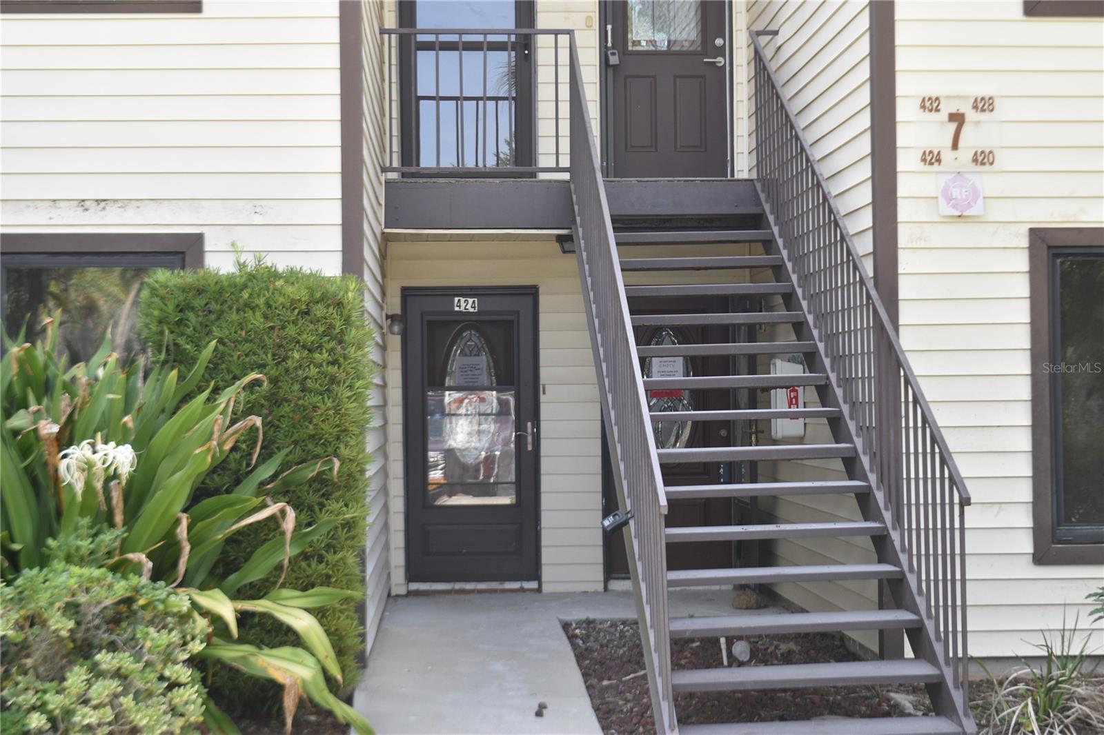 Main entry door behind steps