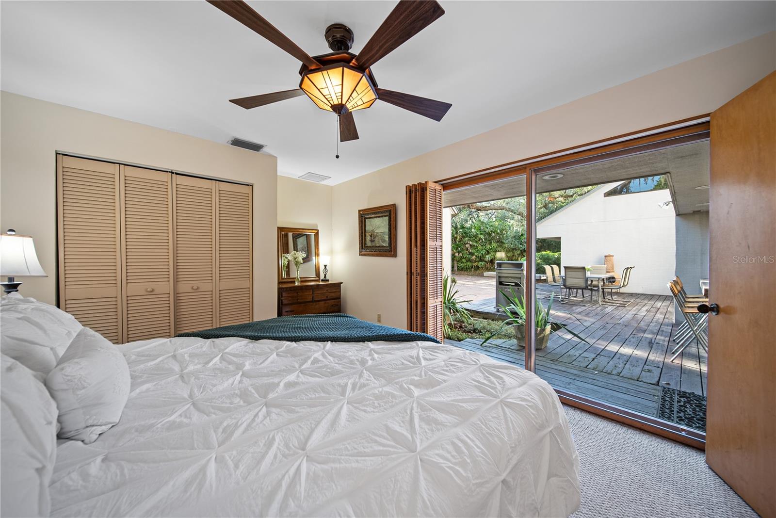 Downstairs Bedroom with lots of light and windows and a sliding glass door leading to the deck.
