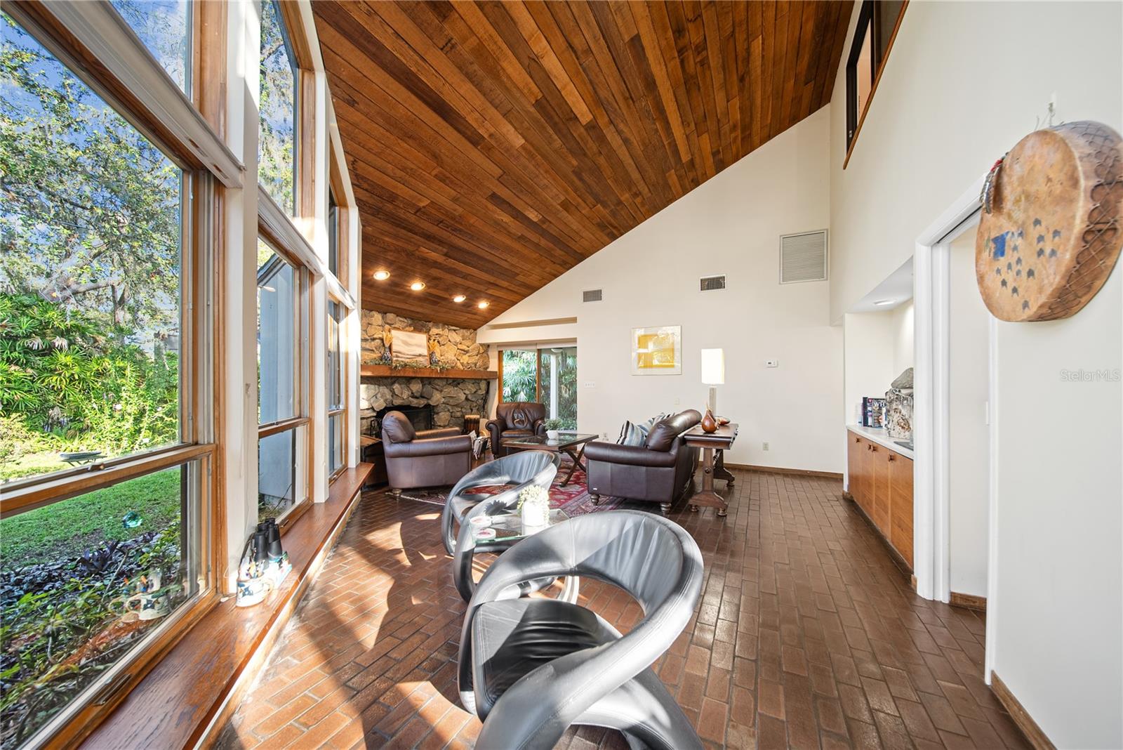 As you enter the home you see a comfortable sitting area to watch nature from the soaring windows.