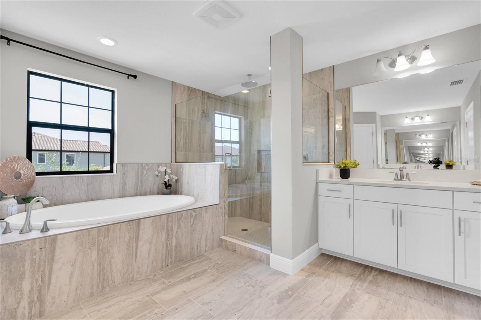 Ensuite bath with dual sinks and rain head shower.