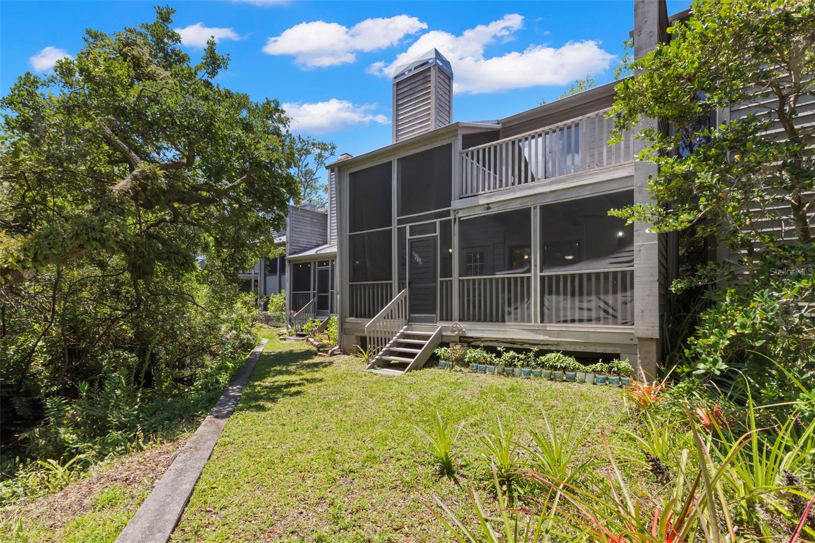 Screen door from lanai gives access to back yard and steps from community pool