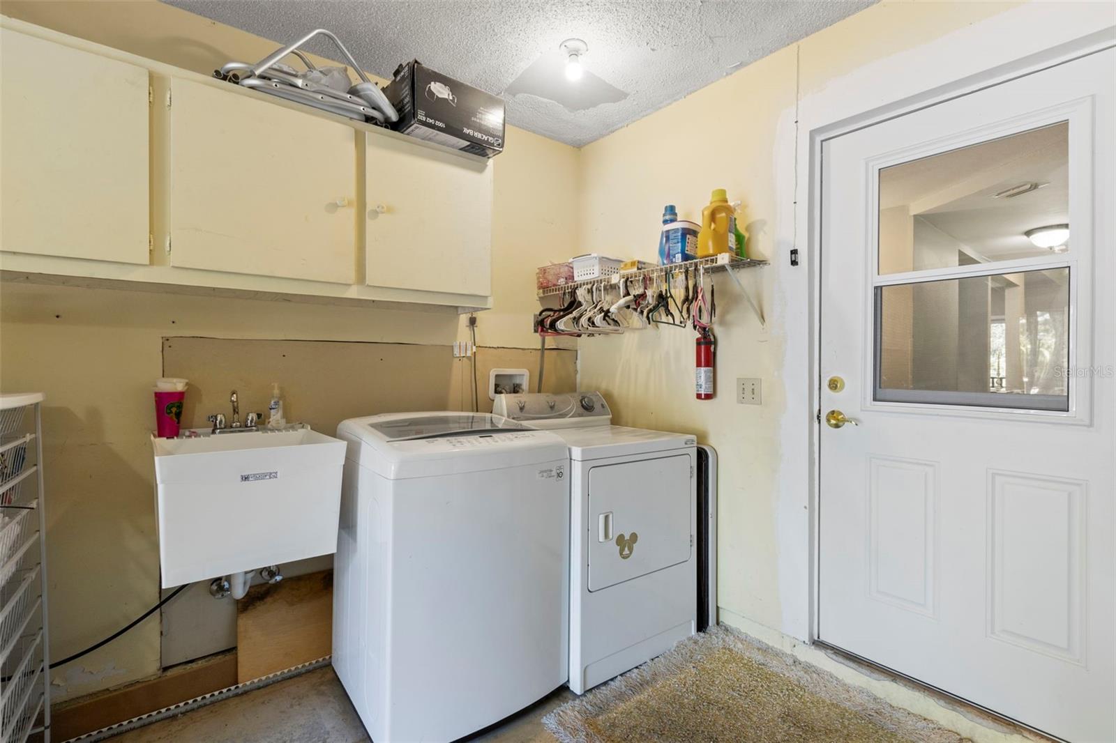 Washer and Dryer are included in garage with utility sink